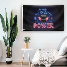 Load image into Gallery viewer, In a home setting, a flag with the saying &quot;V8 Power&quot; is mounted on a white wall by a side table.
