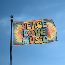 Load image into Gallery viewer, A flag with the saying &quot;Peace Love Music&quot; displayed on a high pole, with a tie dye style color scheme.
