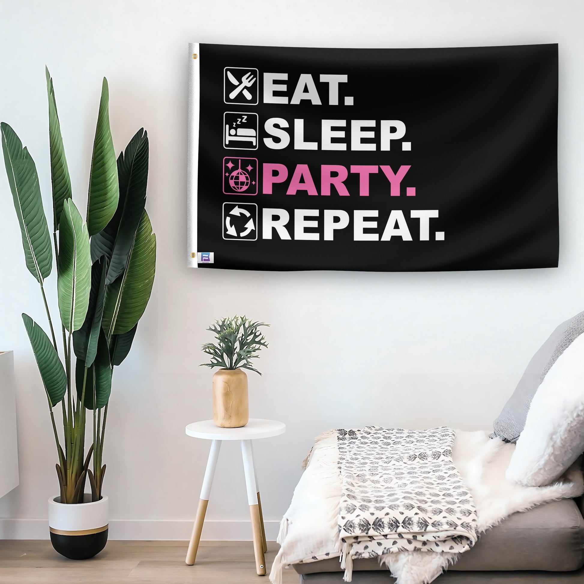 In a home setting, a flag with the saying "Eat Sleep Party Repeat" is mounted on a white wall by a side table.