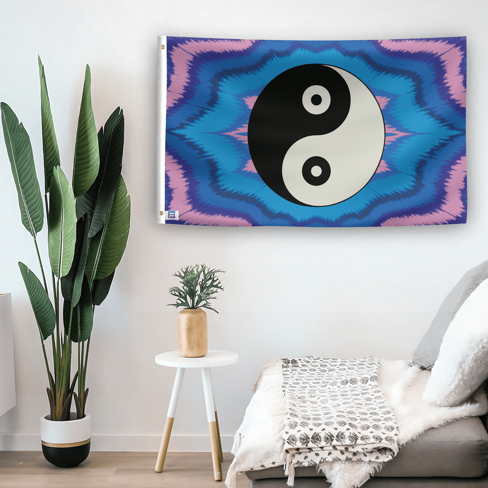 In a home setting, a flag with the saying "Yin and Yang Symbol" is mounted on a white wall by a side table.