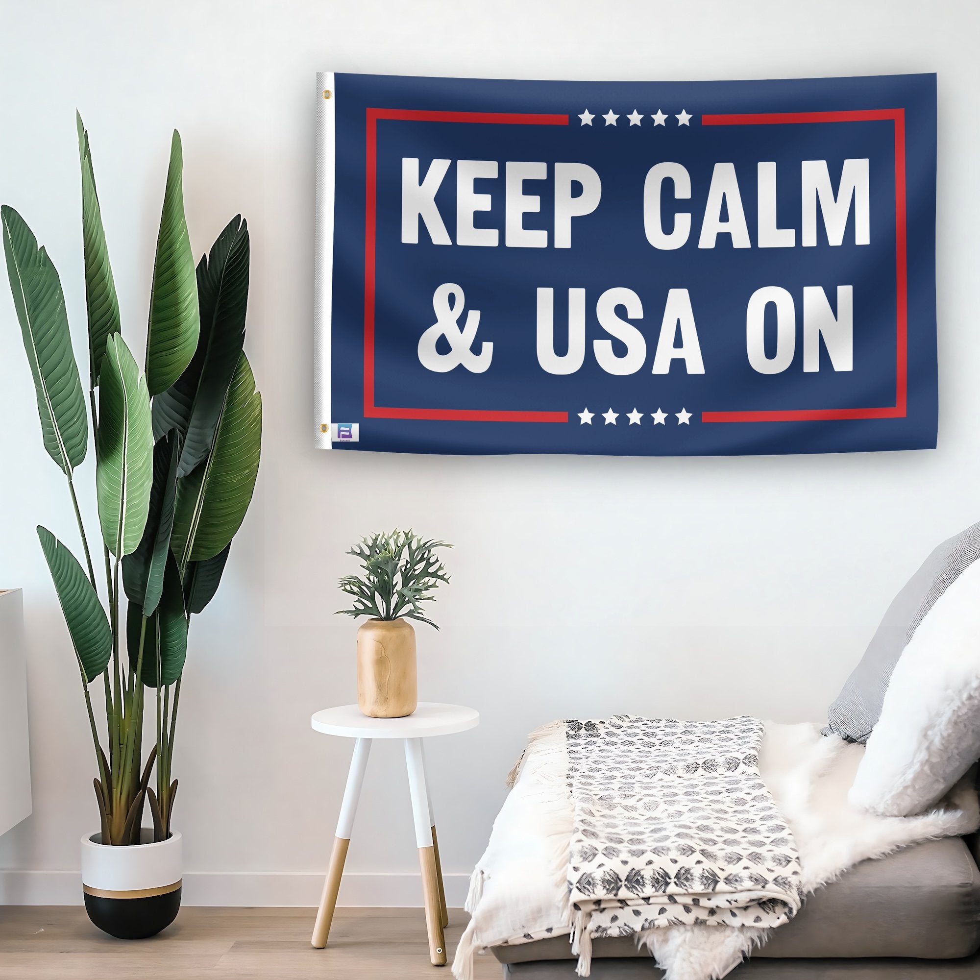 In a home setting, a flag with the saying "Keep Calm And USA On Political" is mounted on a white wall by a side table.