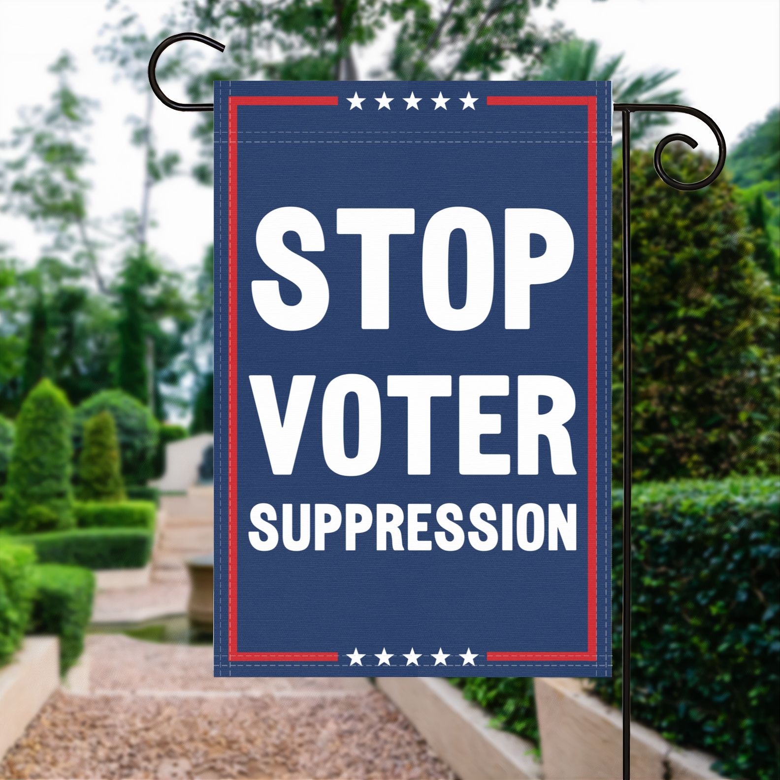 A red, white and blue political garden flag with the slogan Stop Voter Suppression.