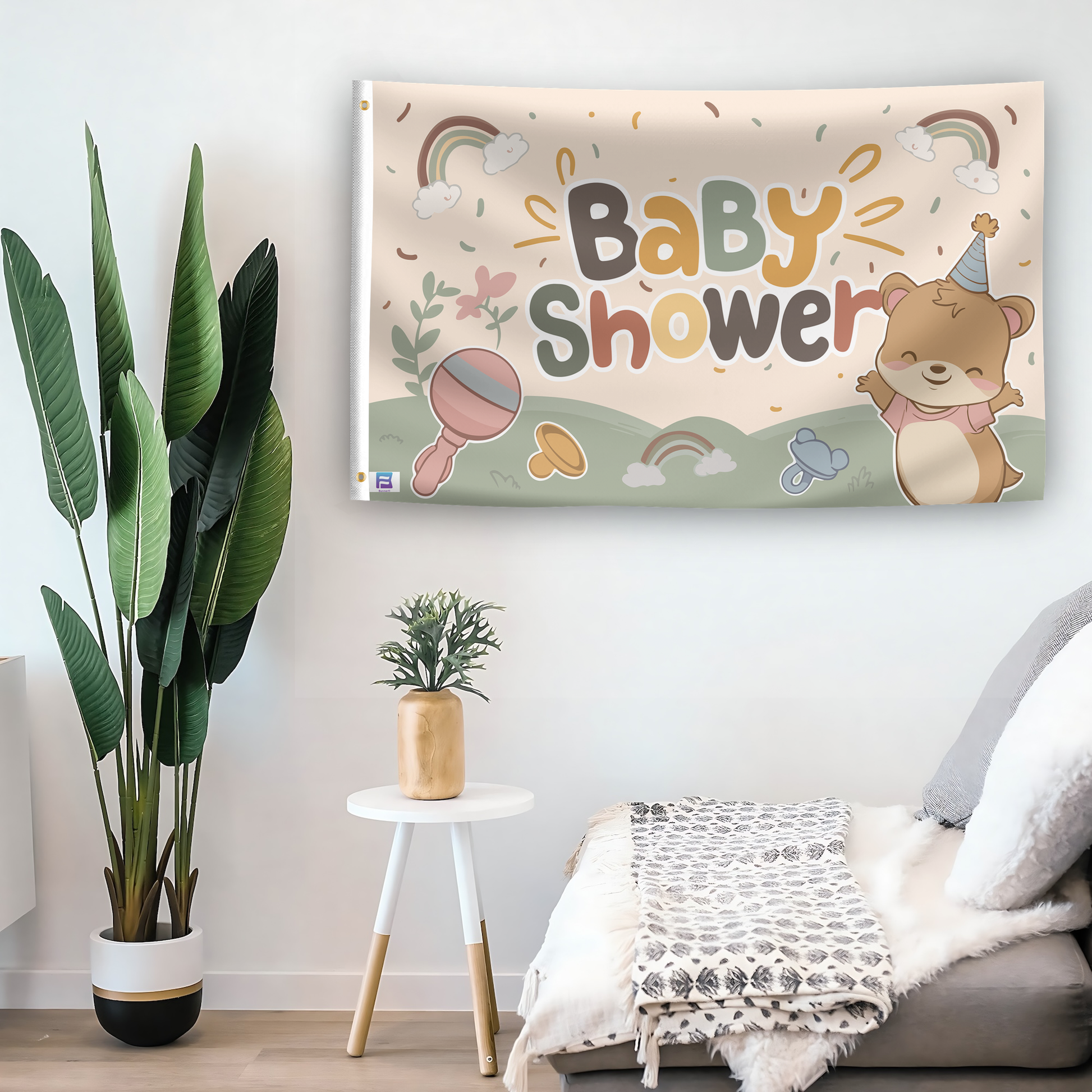 In a home setting, a flag with the saying "Baby Shower" is mounted on a white wall by a side table.