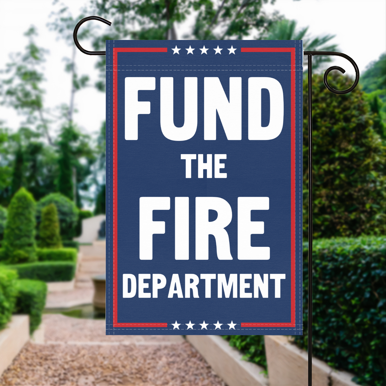 A red, white and blue political garden flag with the slogan Fund The Fire Department.