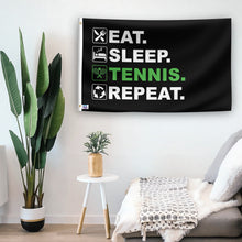 Load image into Gallery viewer, In a home setting, a flag with the saying &quot;Eat Sleep Tennis Repeat&quot; is mounted on a white wall by a side table.
