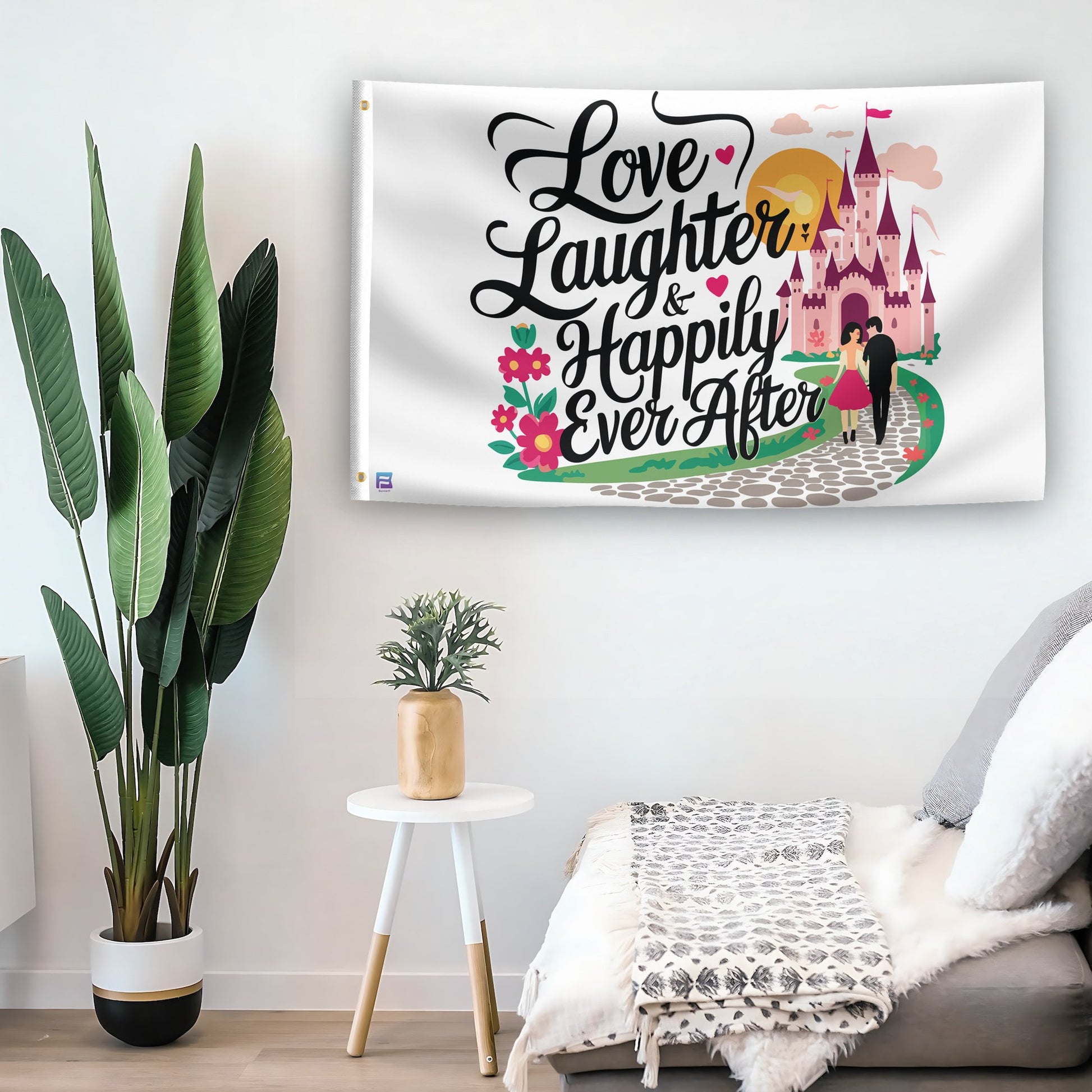 In a home setting, a flag with the saying "Love Laughter & Happily Ever After Fairytale" is mounted on a white wall by a side table.