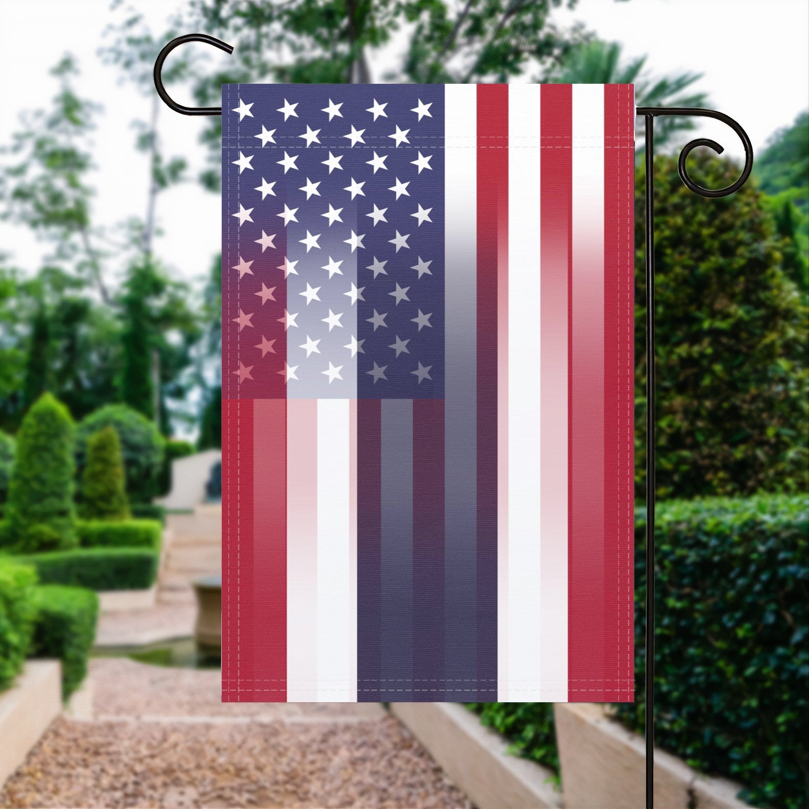 A garden flag with the Thai American flag design seamlessly blended with the American flag, displayed in a garden.