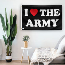 Load image into Gallery viewer, In a home setting, a flag with the saying &quot;I Love The Army&quot; is mounted on a white wall by a side table.
