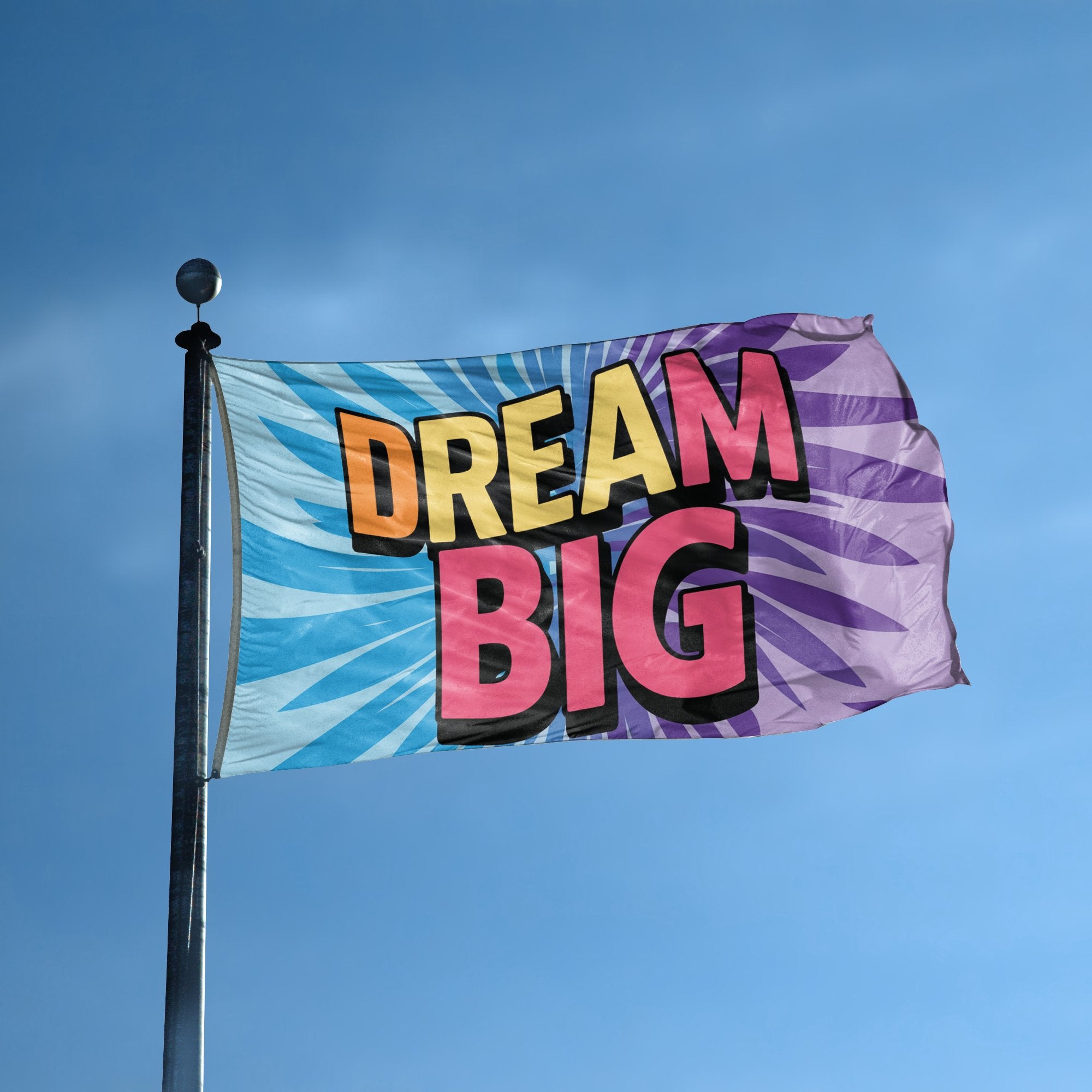 A flag with the saying "Dream Big" displayed on a high pole, with a special occasion color scheme.