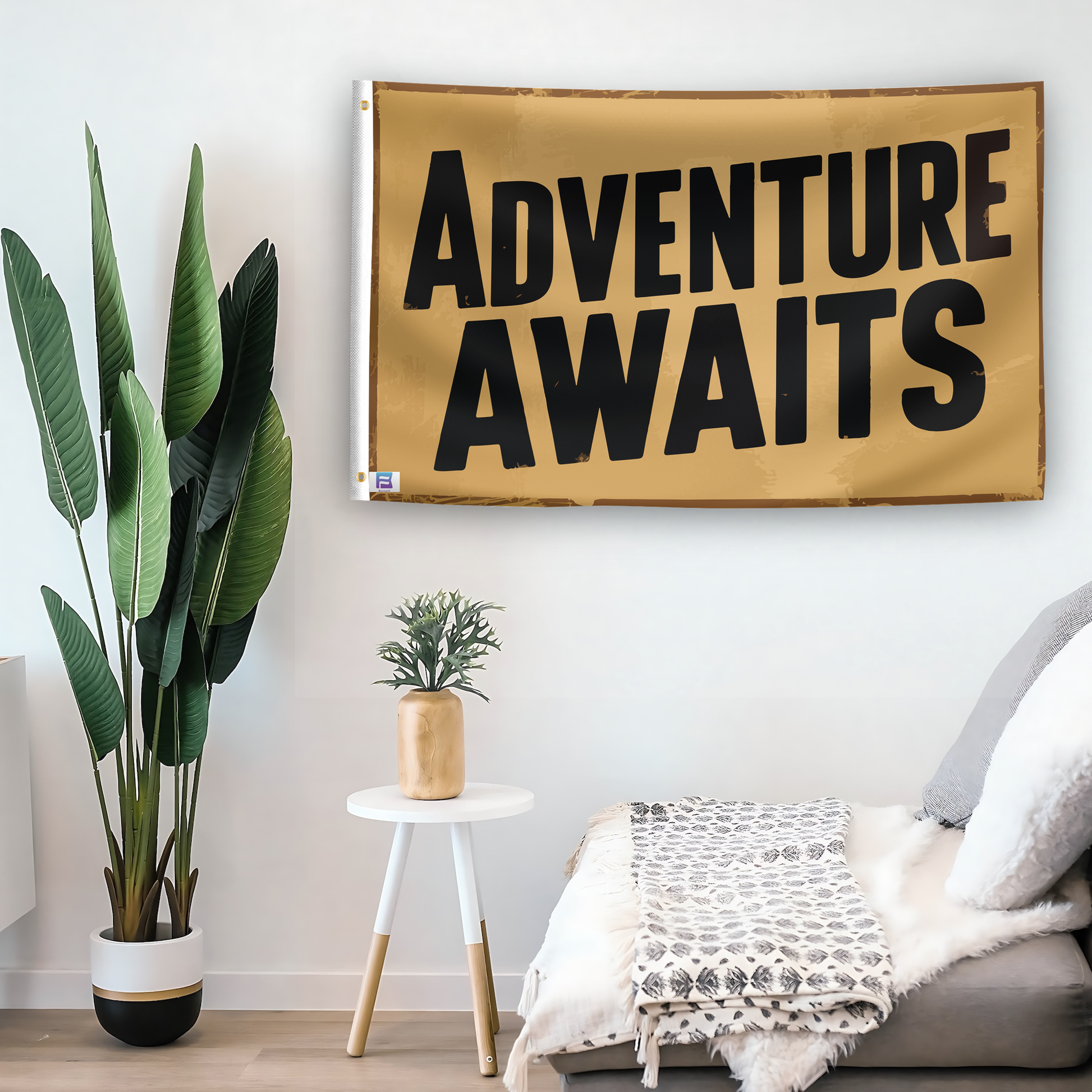 In a home setting, a flag with the saying "Adventure Awaits" is mounted on a white wall by a side table.