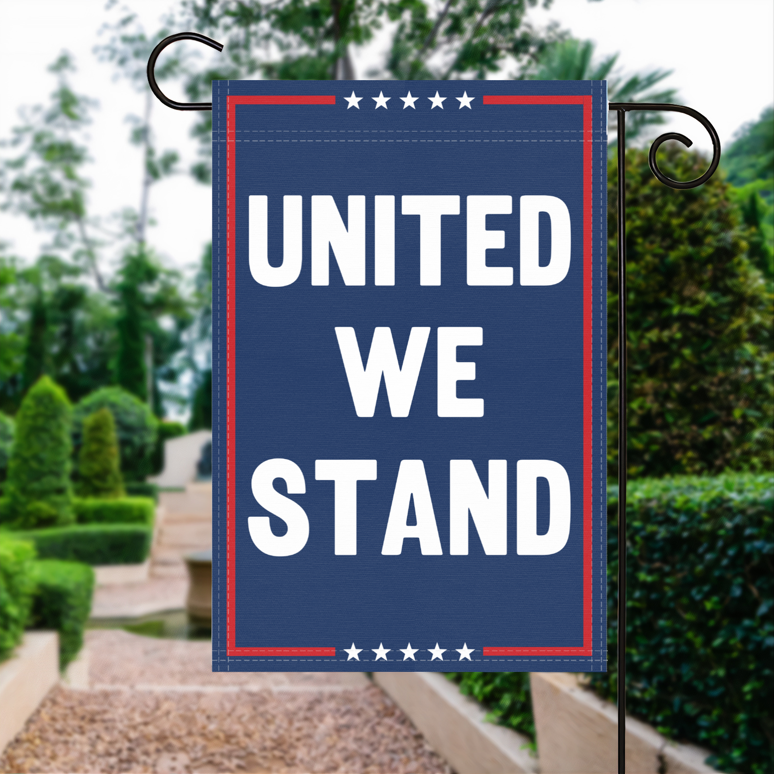 A red, white and blue political garden flag with the slogan United We Stand.