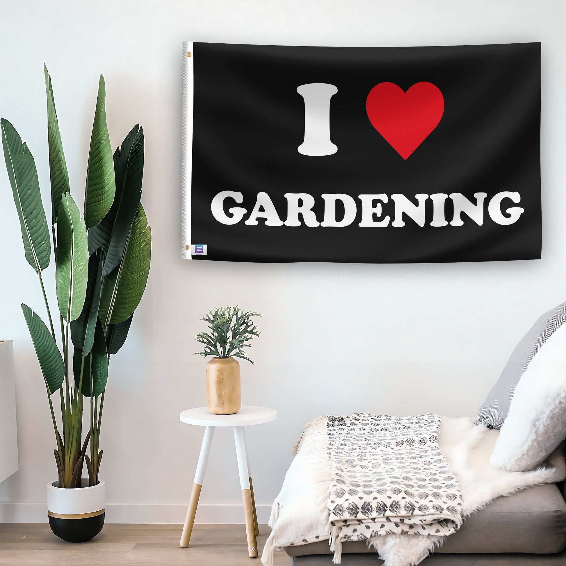 In a home setting, a flag with the saying "I Love Gardening" is mounted on a white wall by a side table.