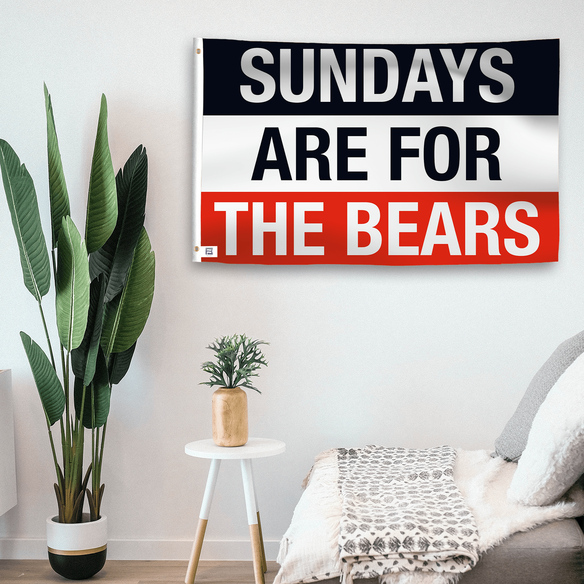 In a home setting, a flag with the saying "https://www.dropbox.com/scl/fi/wmw2phyxegy4fwbgnxv69/sundays-are-for-the-bears_room.png?rlkey=xrpqtxtnpfejosgkb14inzcx9&raw=1" is mounted on a white wall by a side table.