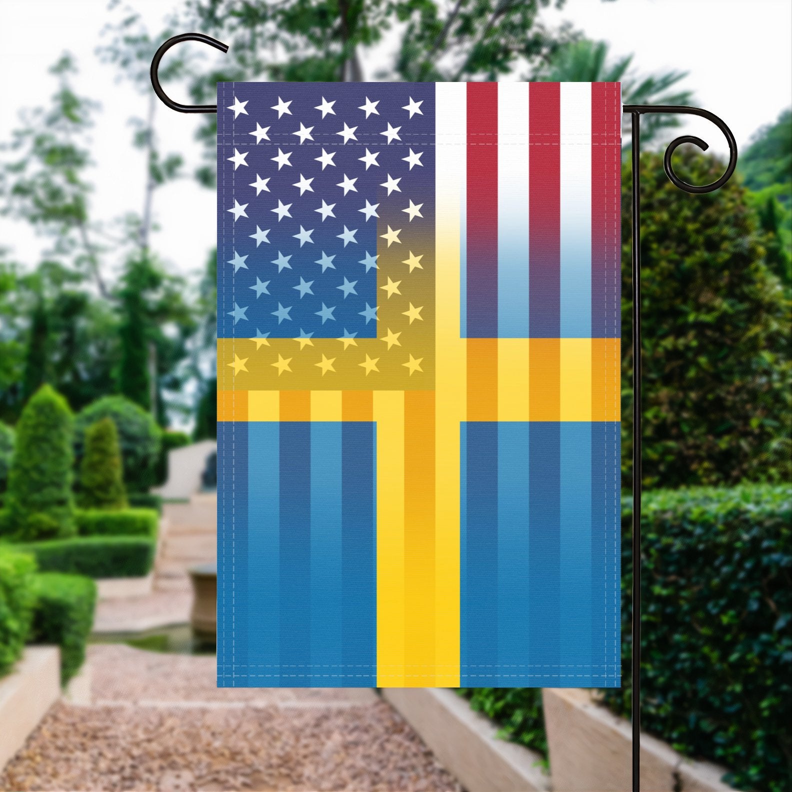 A garden flag with the Swedish American flag design seamlessly blended with the American flag, displayed in a garden.