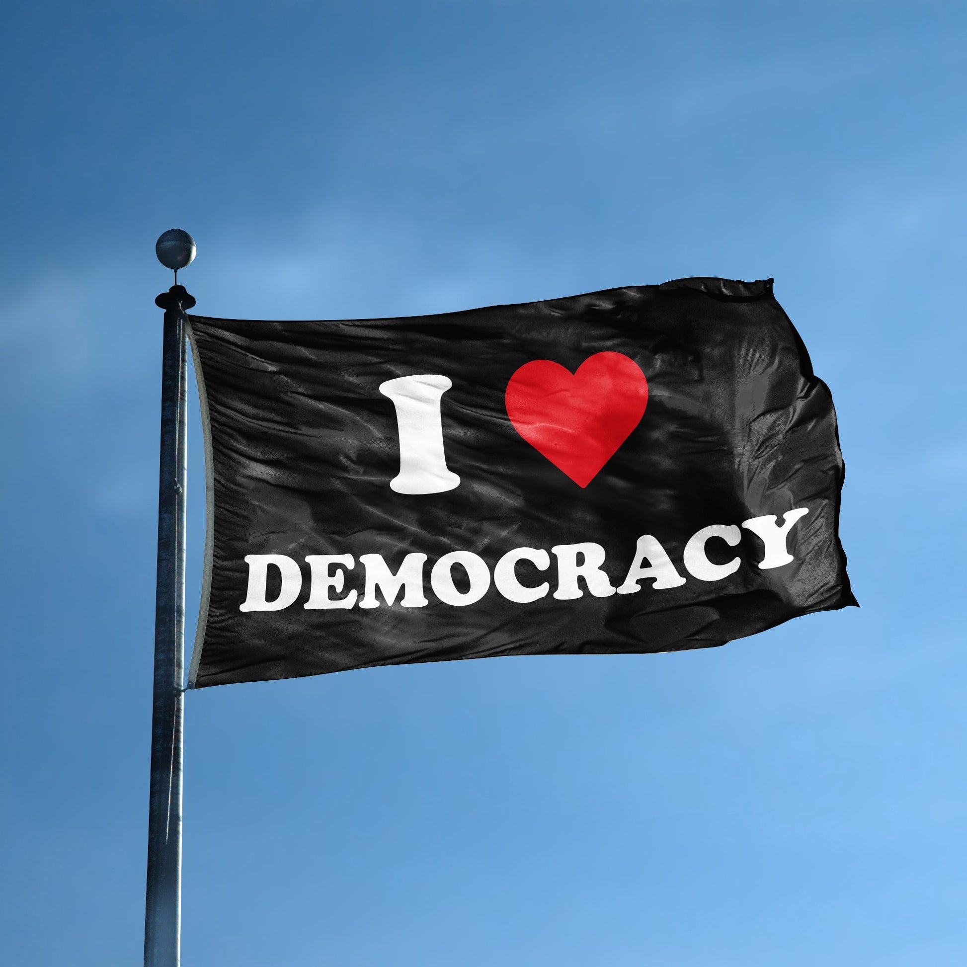 A flag with the saying "I Love Democracy" displayed on a high pole, with a black, white and red color scheme.