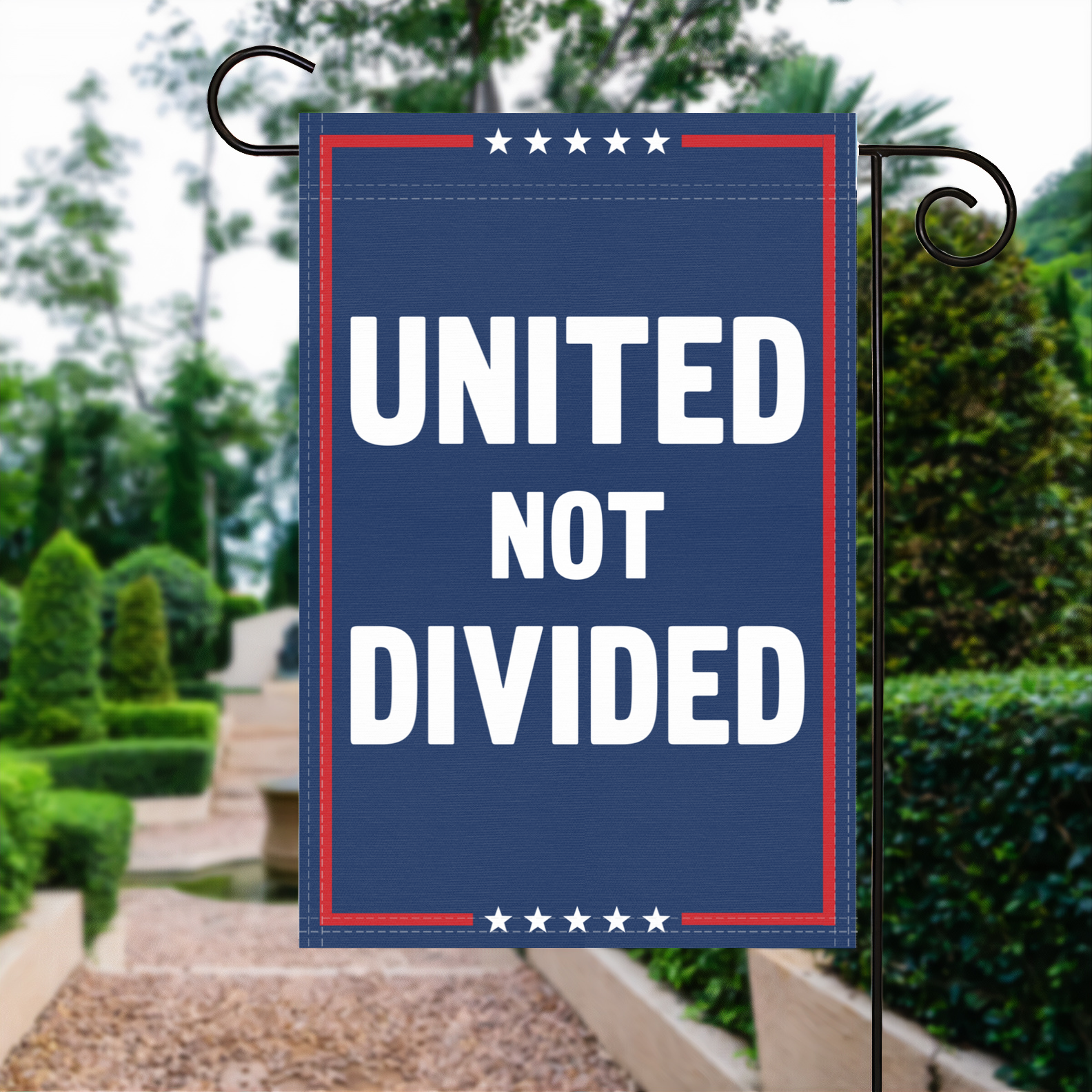 A red, white and blue political garden flag with the slogan United Not Divided.