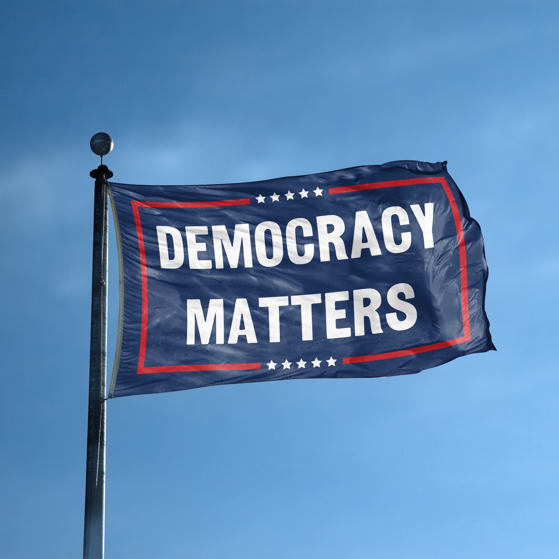 A flag with the saying "Democracy Matters Political" displayed on a high pole, with a red, white, and blue color scheme.