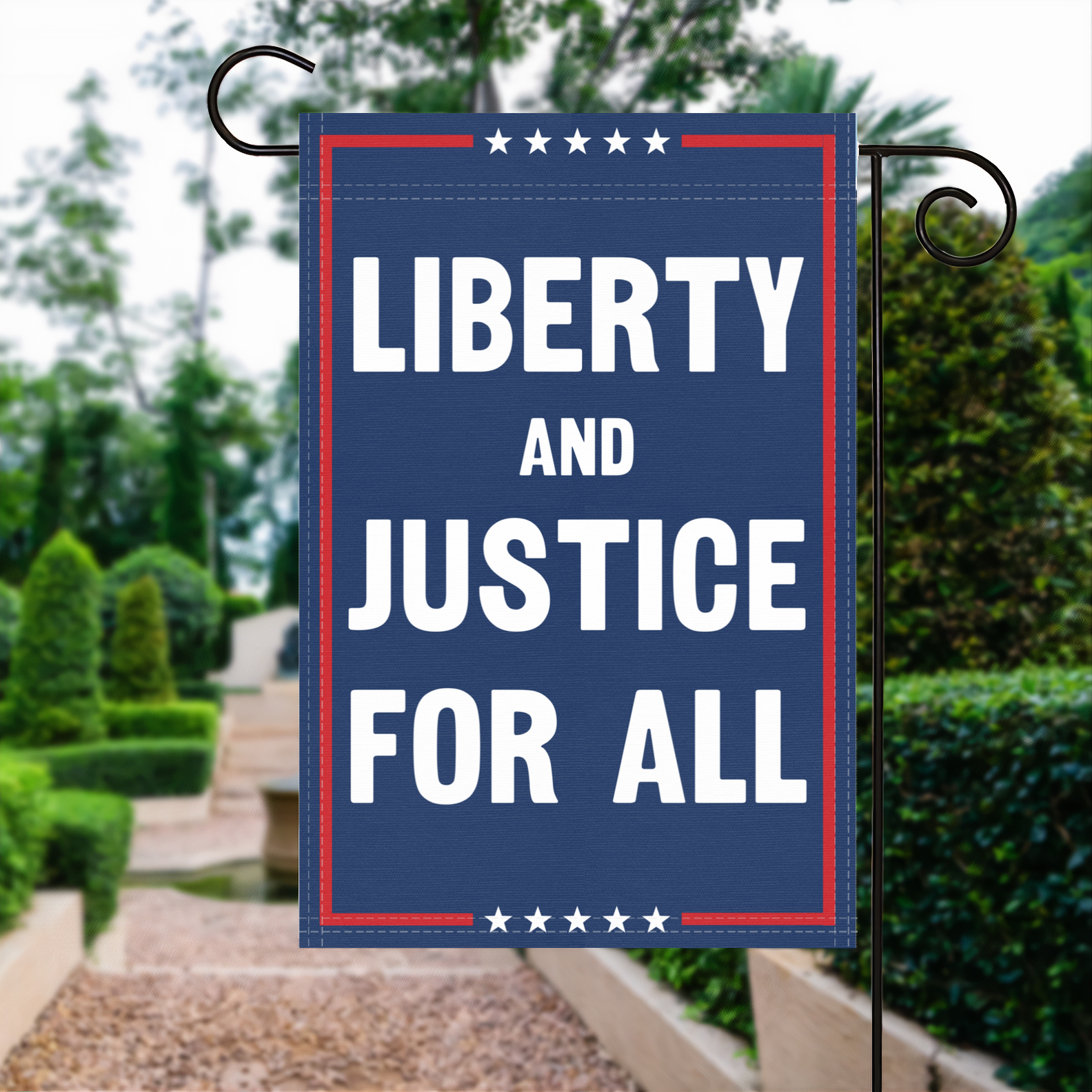 A red, white and blue political garden flag with the slogan Liberty And Justice For All.