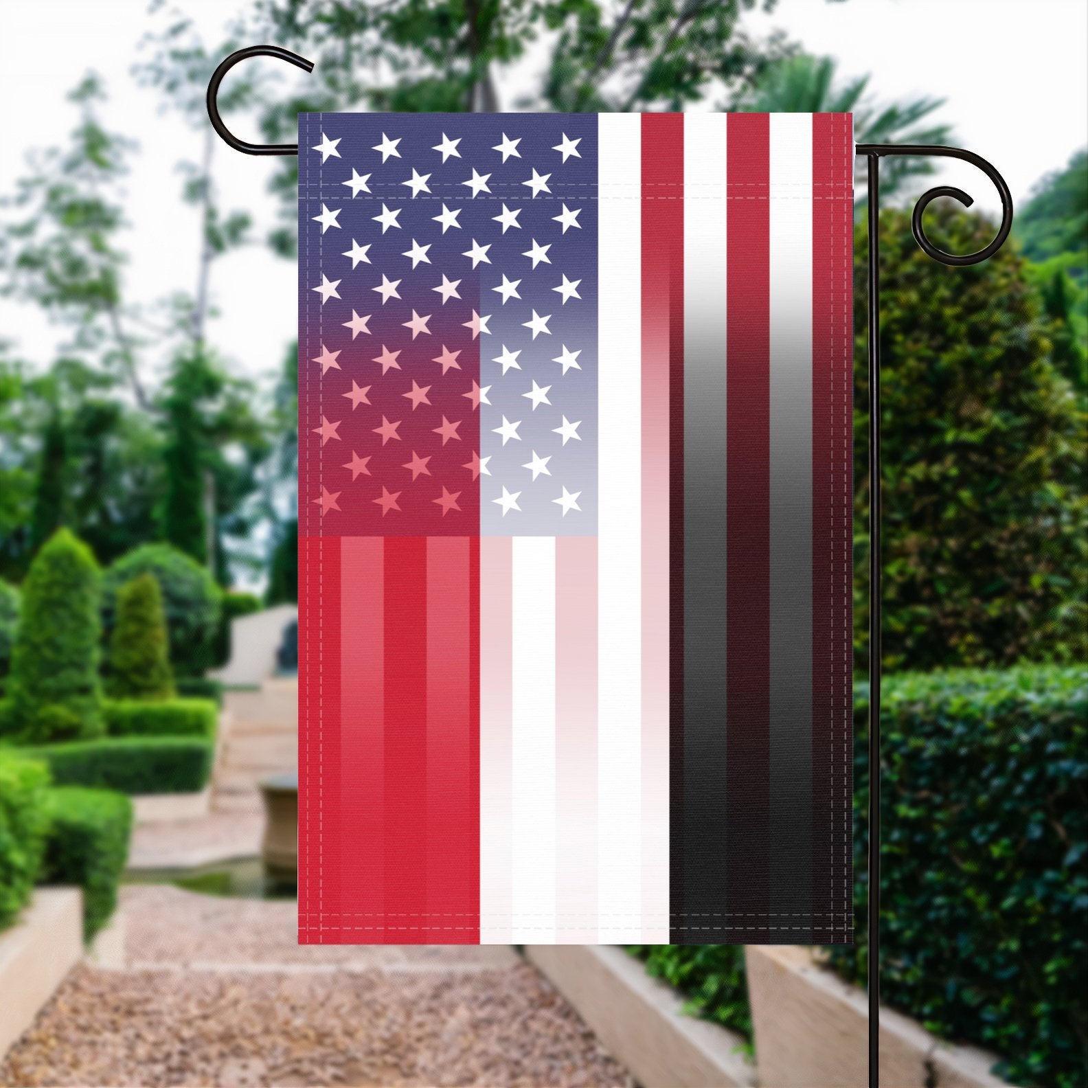 A garden flag with the Yemeni American flag design seamlessly blended with the American flag, displayed in a garden.