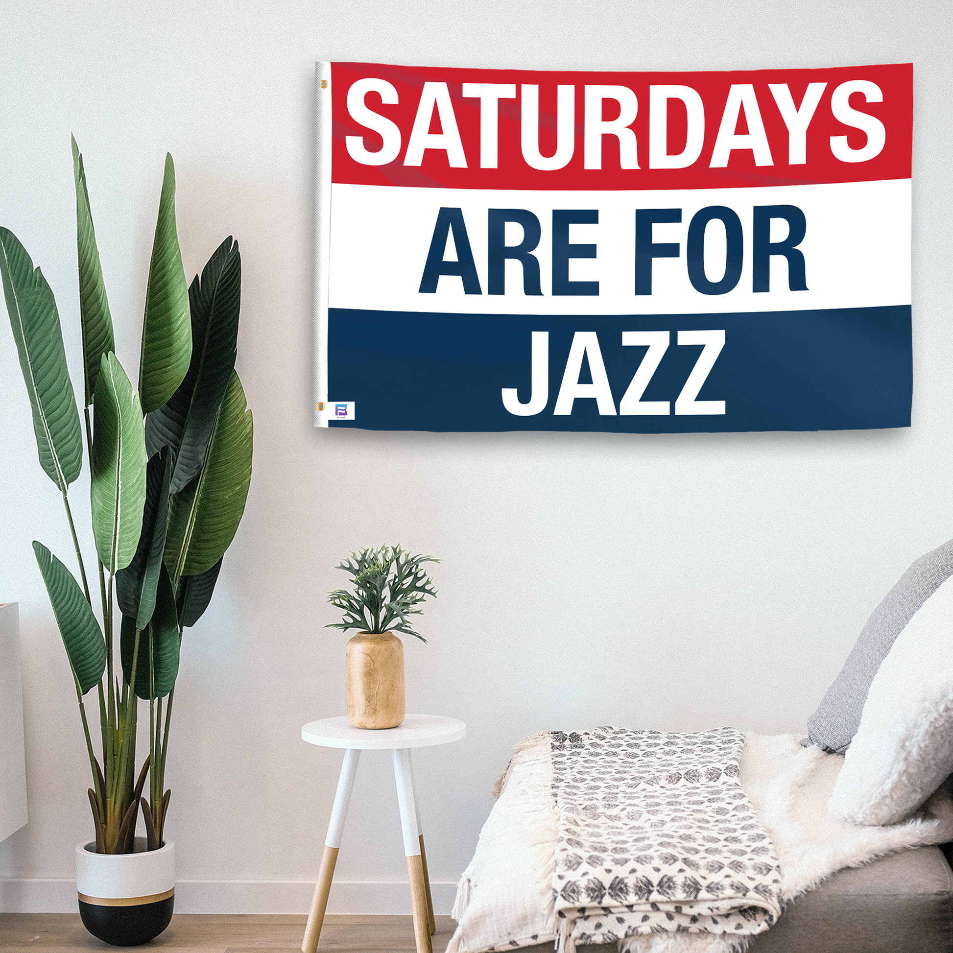 In a home setting, a flag with the saying "https://www.dropbox.com/scl/fi/7rjz49o5qlgmut1z5uiwl/saturdays-are-for-jazz_room.png?rlkey=y57zjm7m6xdpq2se1sr4iu5ty&raw=1" is mounted on a white wall by a side table.