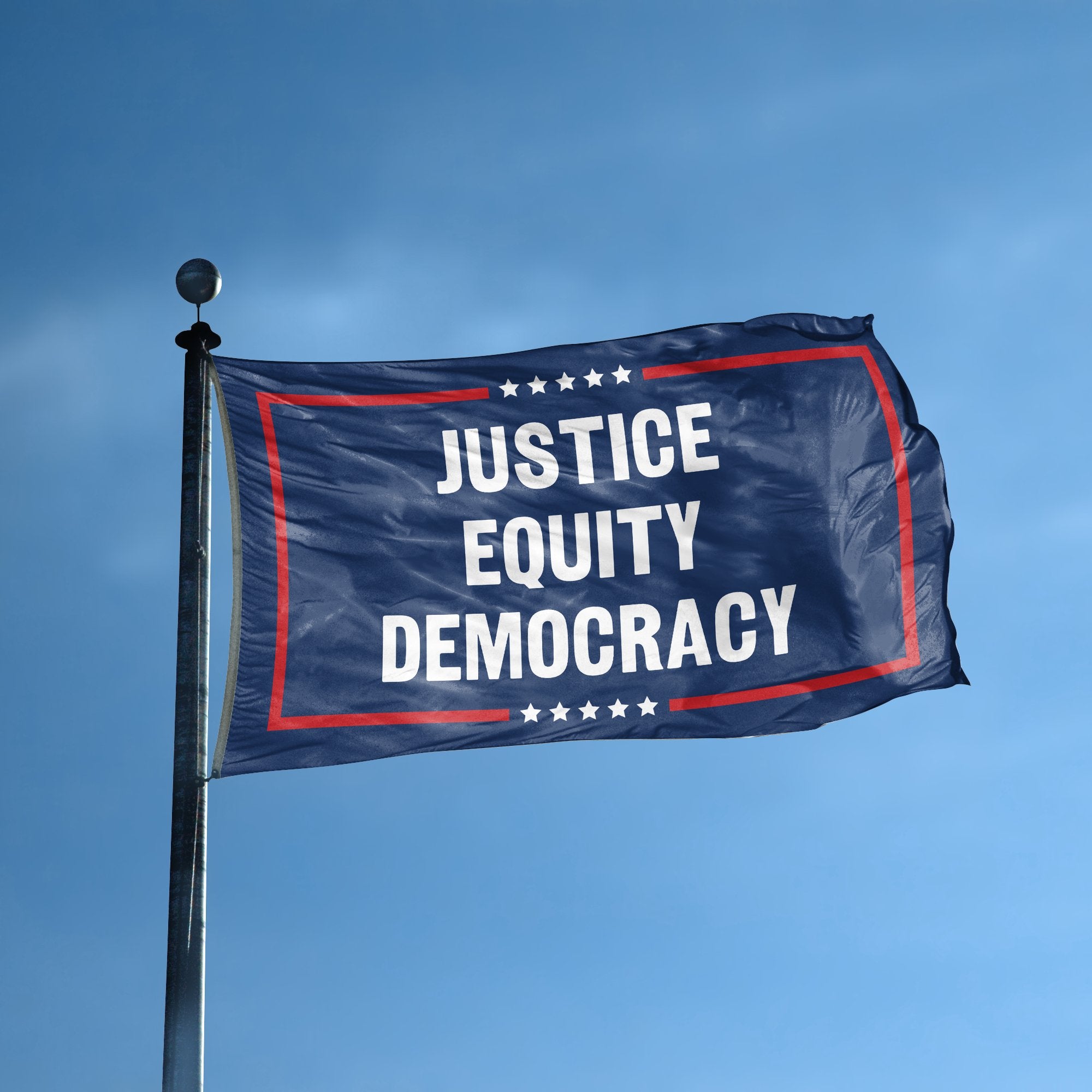 A flag with the saying "Justice Equity Democracy Political" displayed on a high pole, with a red, white, and blue color scheme.