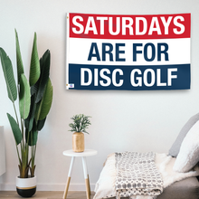 Load image into Gallery viewer, In a home setting, a flag with the saying &quot;https://www.dropbox.com/scl/fi/jx4bk1noz36l78yeb95uh/saturdays-are-for-disc-golf_room.png?rlkey=l08scfv6tqo31ln54x2j6k44l&amp;raw=1&quot; is mounted on a white wall by a side table.
