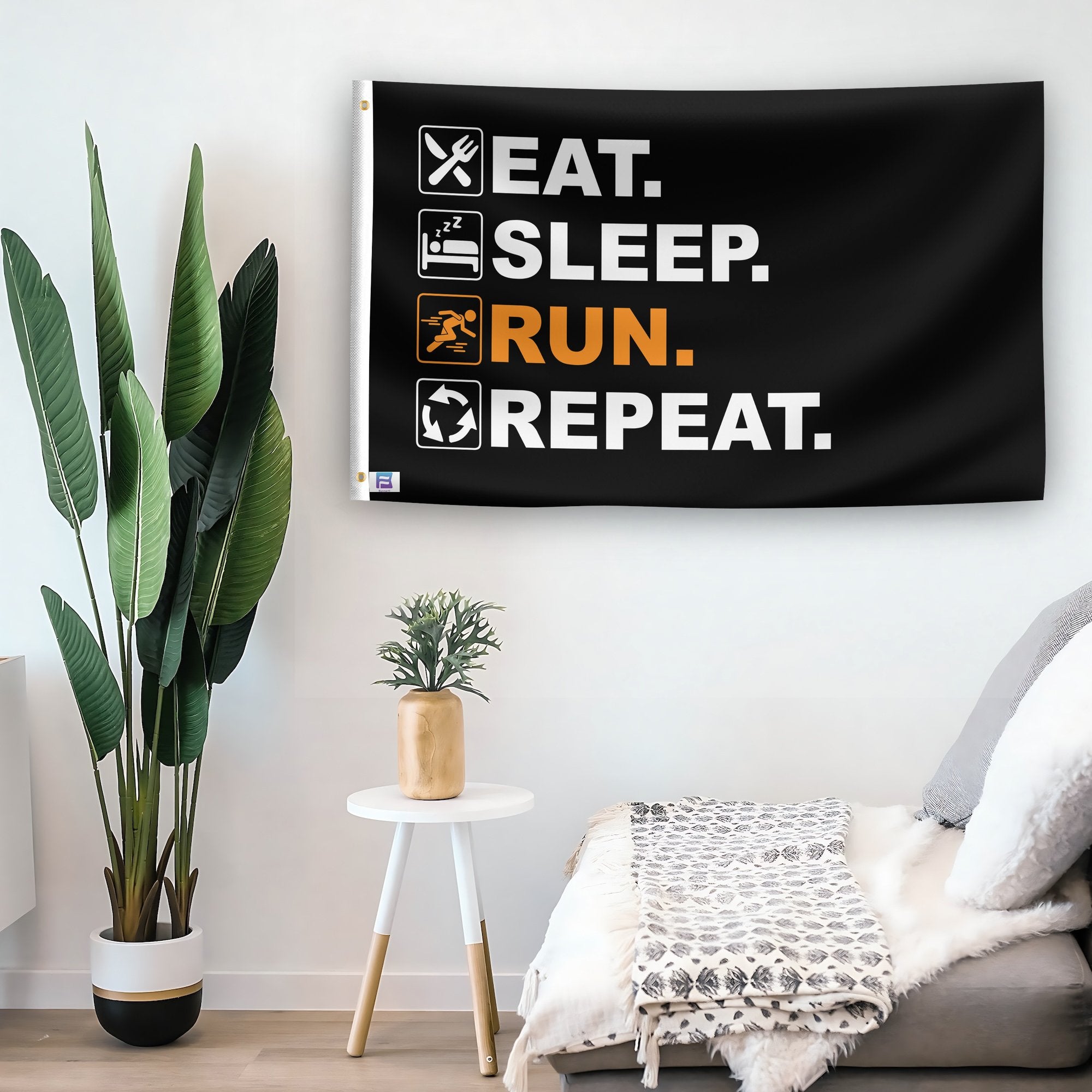 In a home setting, a flag with the saying "Eat Sleep Run Repeat" is mounted on a white wall by a side table.