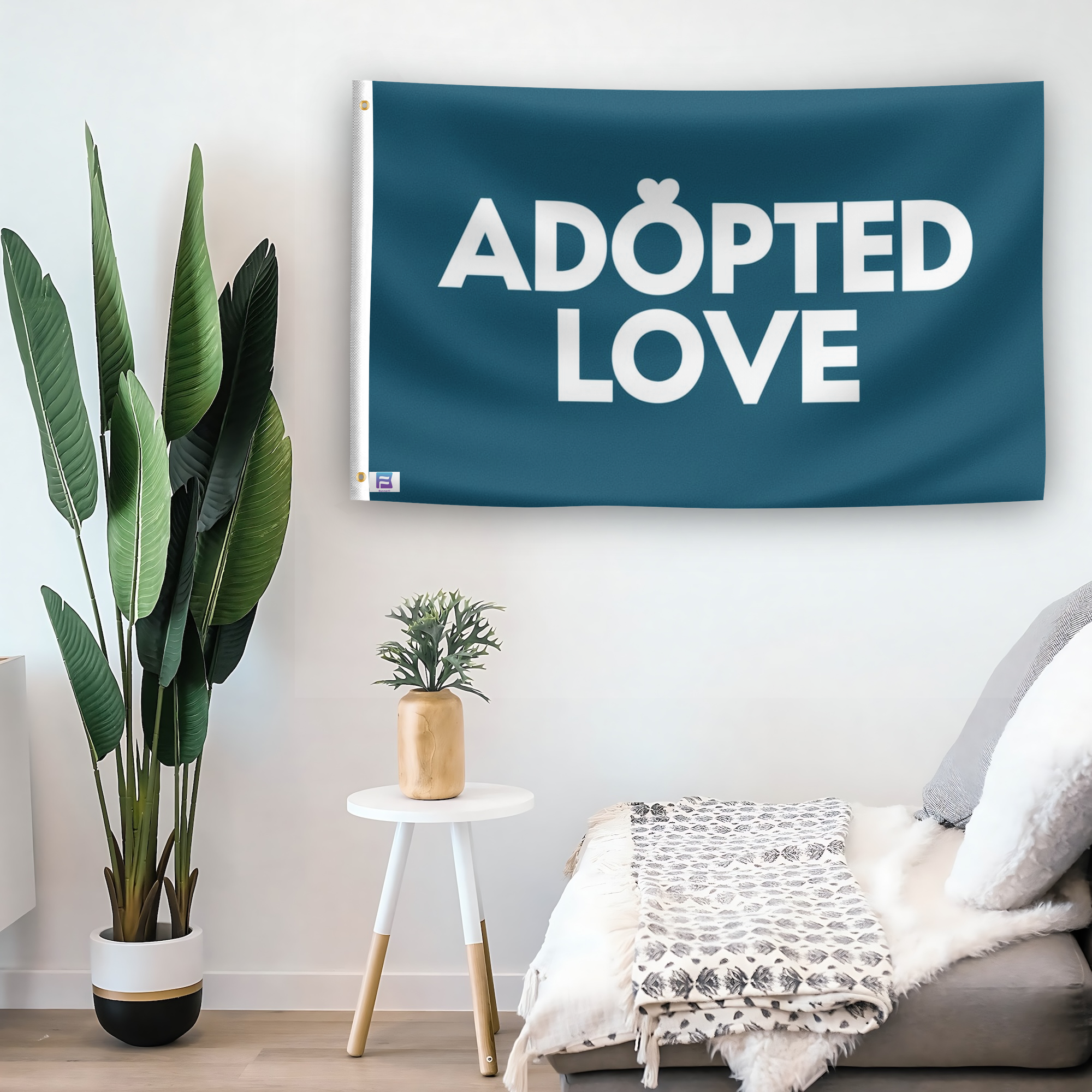 In a home setting, a flag with the saying "Adopted Love Pet" is mounted on a white wall by a side table.