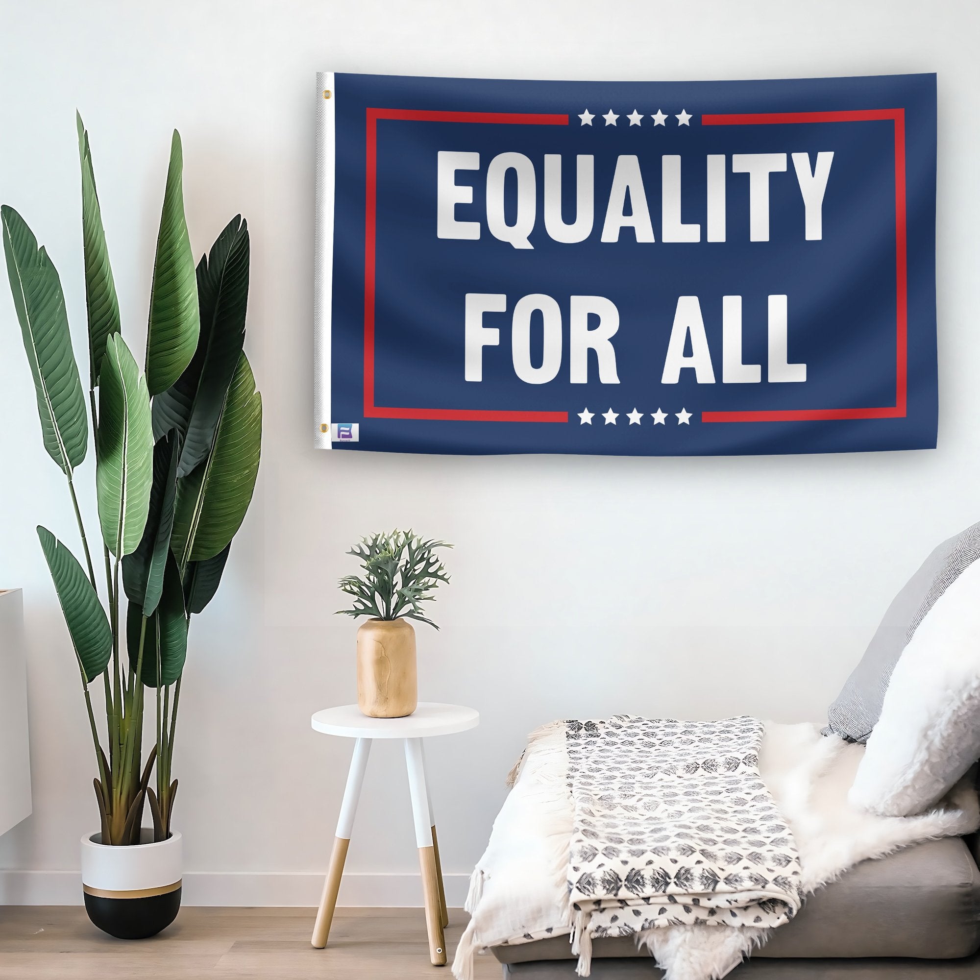 In a home setting, a flag with the saying "Equality For All Political" is mounted on a white wall by a side table.