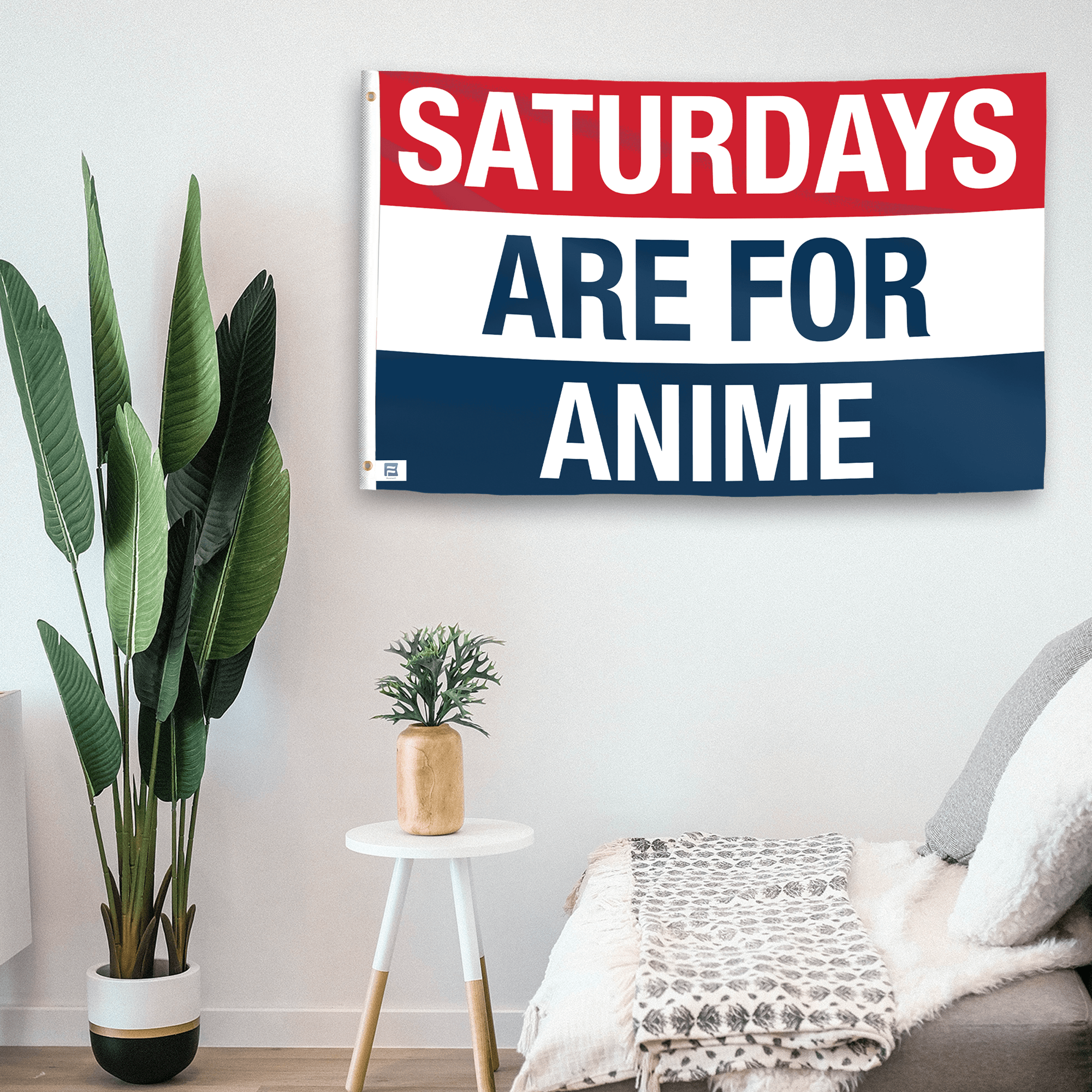 In a home setting, a flag with the saying "https://www.dropbox.com/scl/fi/ijnuwk2sg6dw4sgjv8bkz/saturdays-are-for-anime_room.png?rlkey=ua91xh8is79tl7jyx7n0jadvg&raw=1" is mounted on a white wall by a side table.