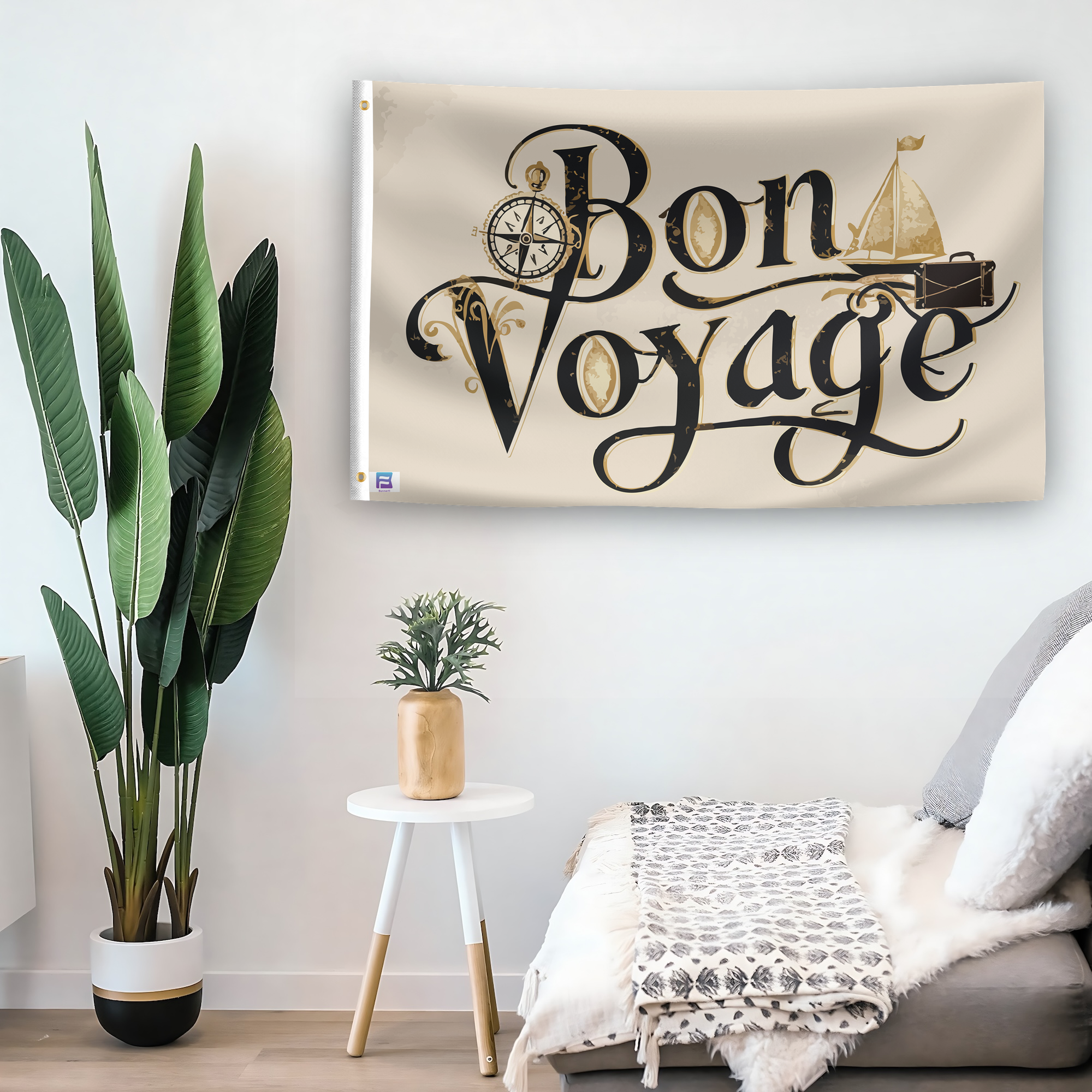 In a home setting, a flag with the saying "Bon Voyage" is mounted on a white wall by a side table.