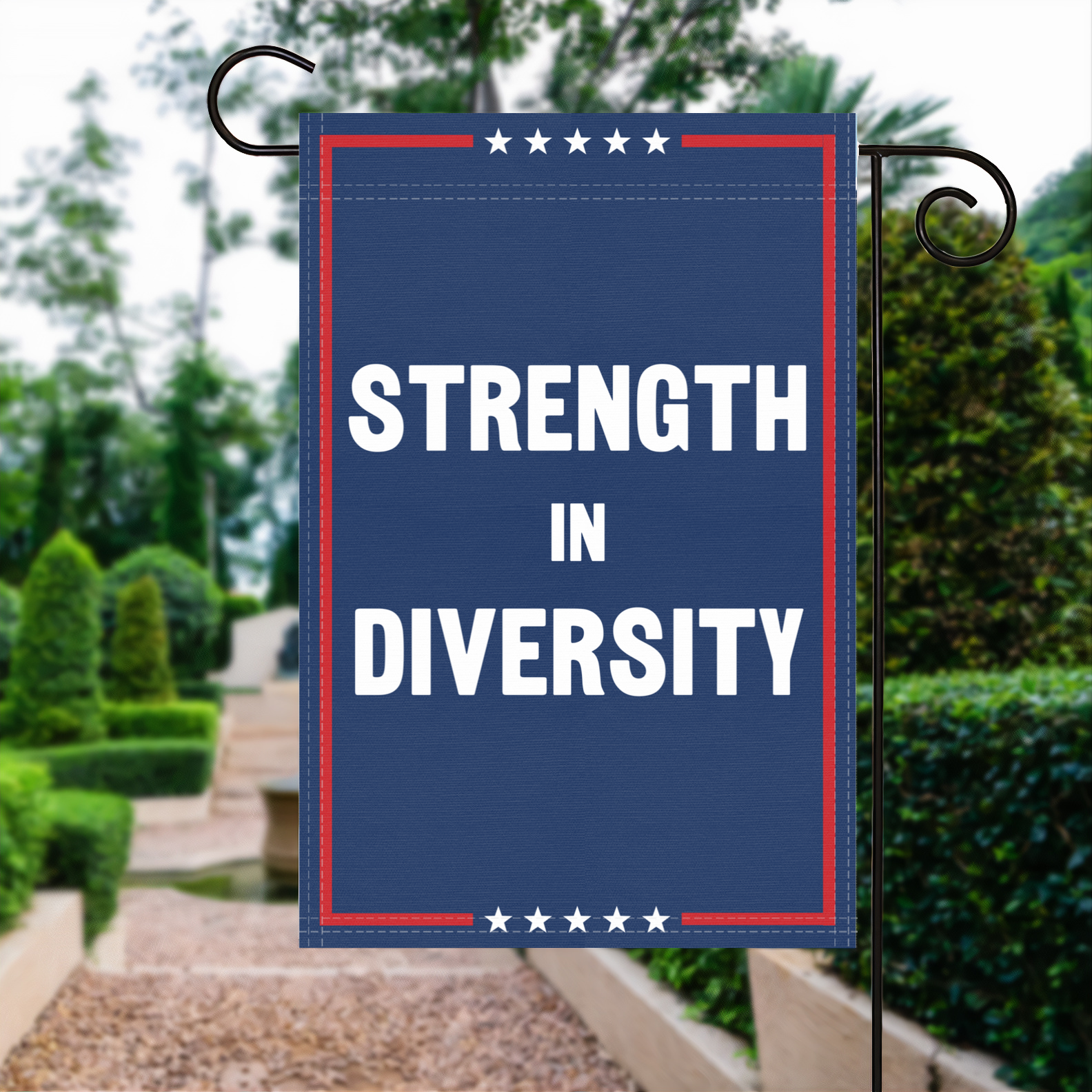 A red, white and blue political garden flag with the slogan Strength In Diversity.