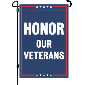 A red, white and blue political garden flag on a pole with the slogan Honor Our Veterans.
