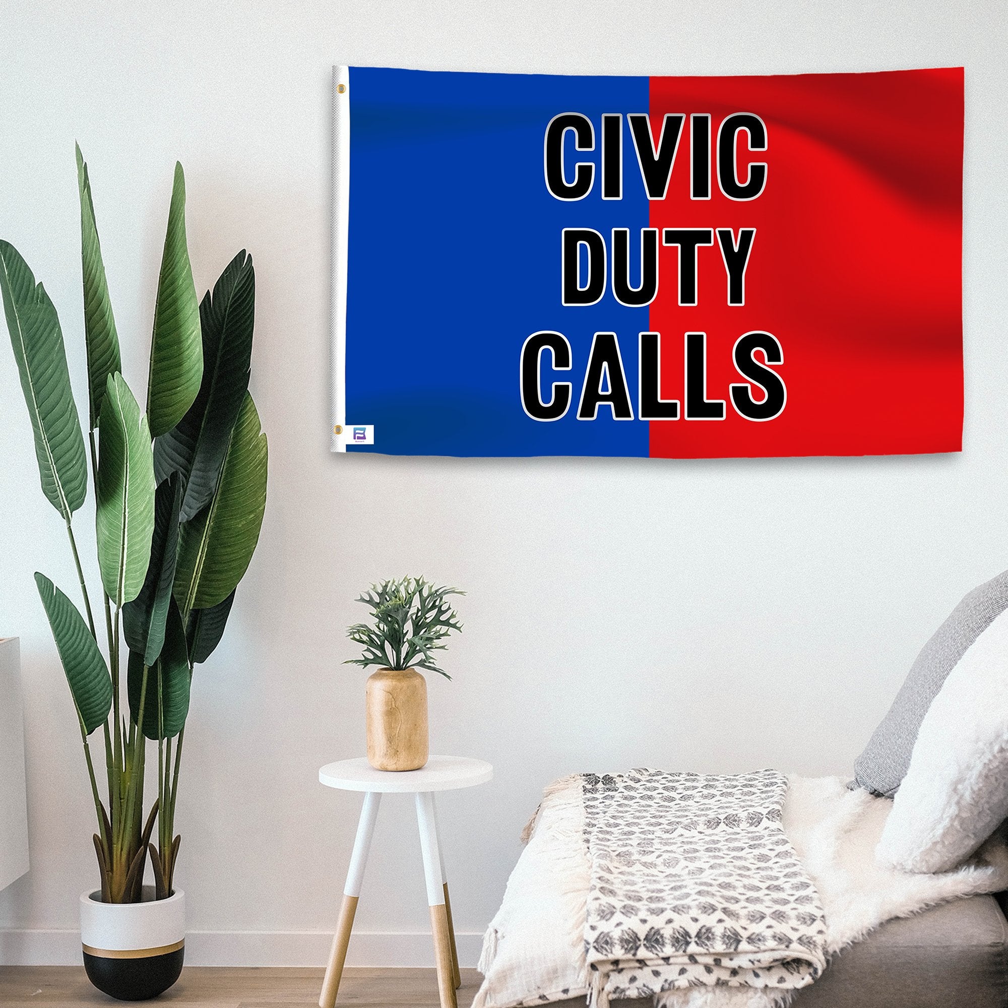 In a home setting, a blue and red flag with a political slogan is mounted on a white wall by a side table.