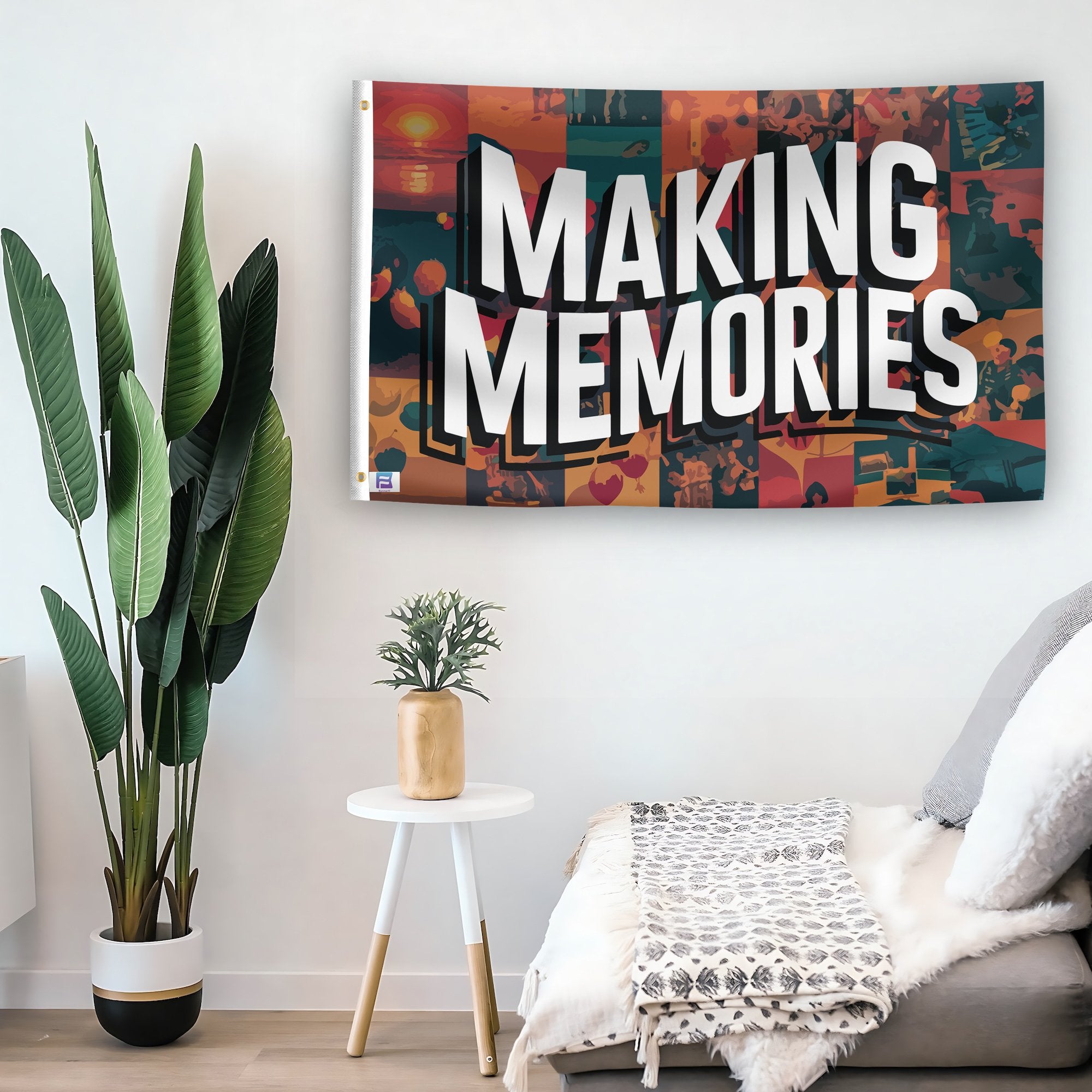 In a home setting, a flag with the saying "Making Memories" is mounted on a white wall by a side table.