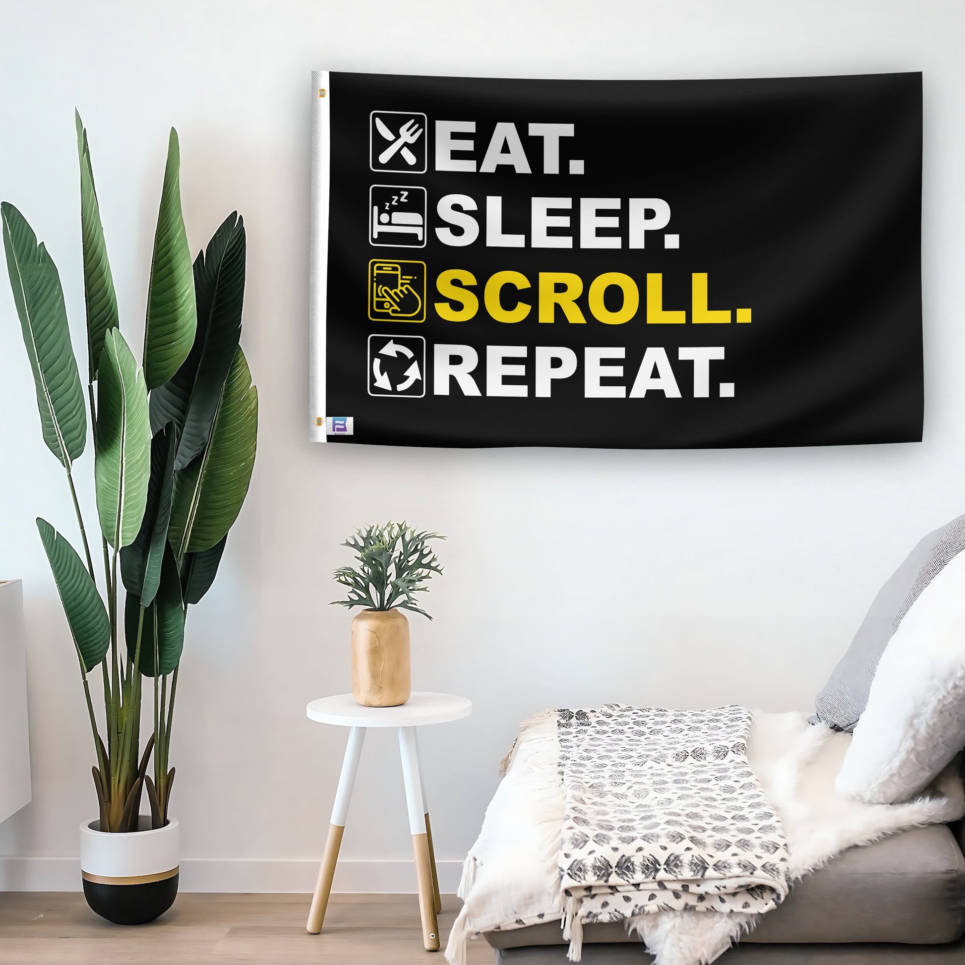 In a home setting, a flag with the saying "Eat Sleep Scroll Repeat" is mounted on a white wall by a side table.