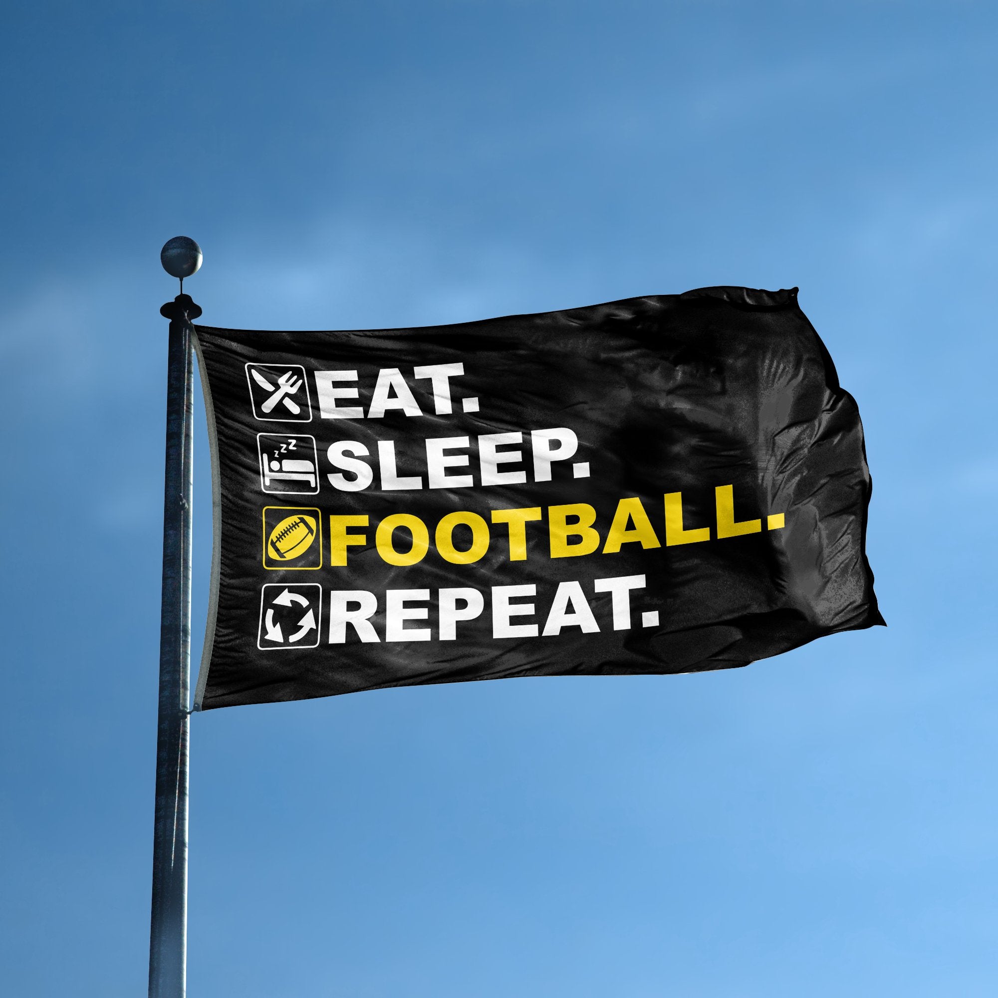 A flag with the saying "Eat Sleep Football Repeat" displayed on a high pole, with a black, white and themed color scheme.