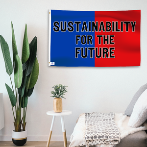 In a home setting, a blue and red flag with a political slogan is mounted on a white wall by a side table.