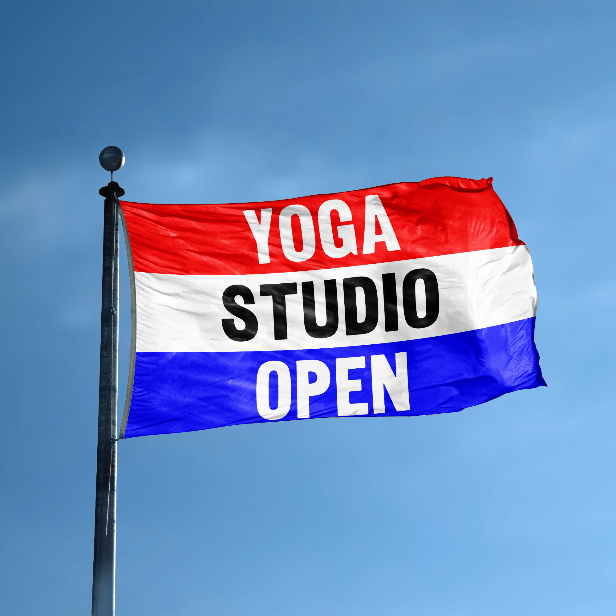 A business banner with the saying "Yoga Studio Open" displayed on a high pole, with a red, white, and blue color scheme.