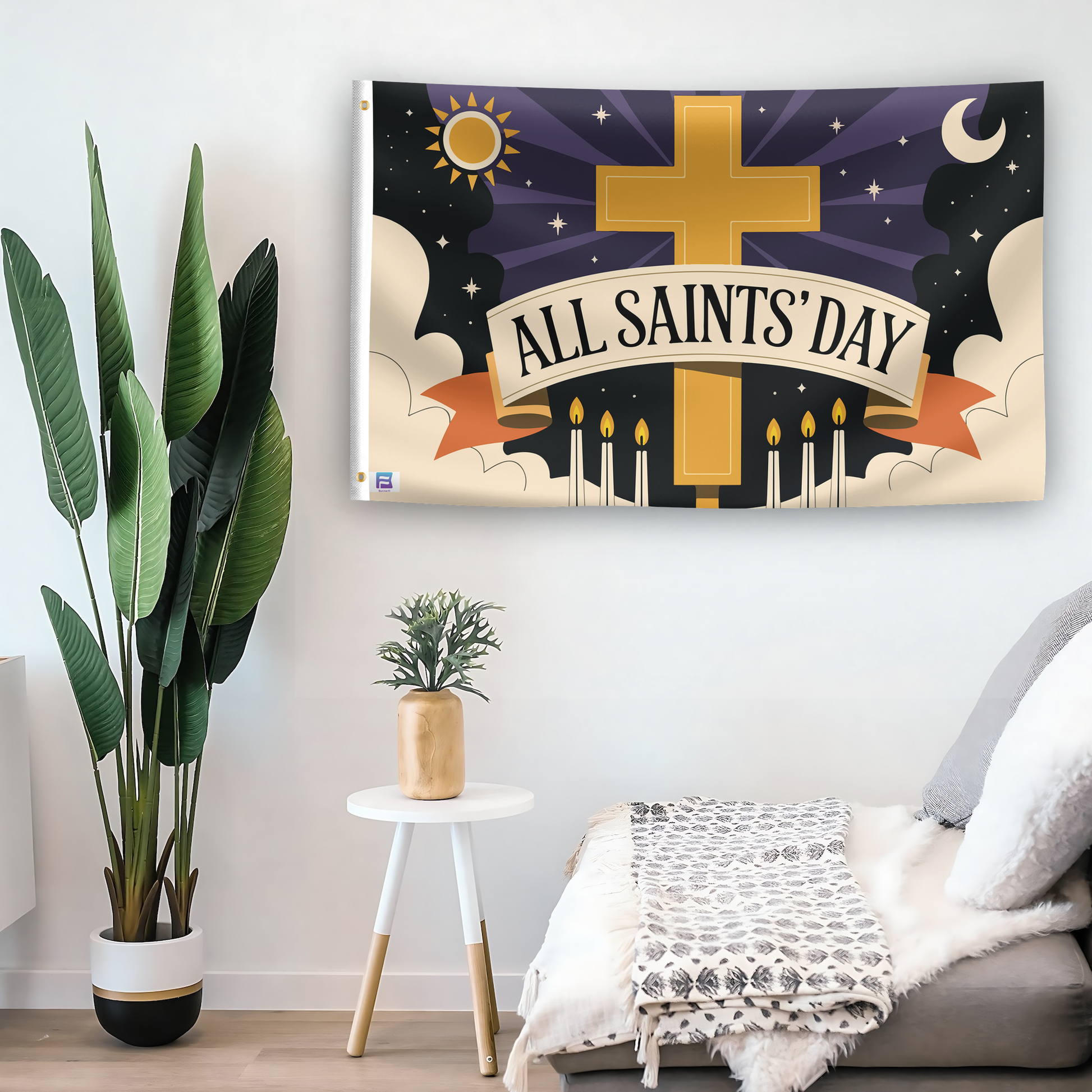 In a home setting, a flag with the saying "All Saints' Day" is mounted on a white wall by a side table.