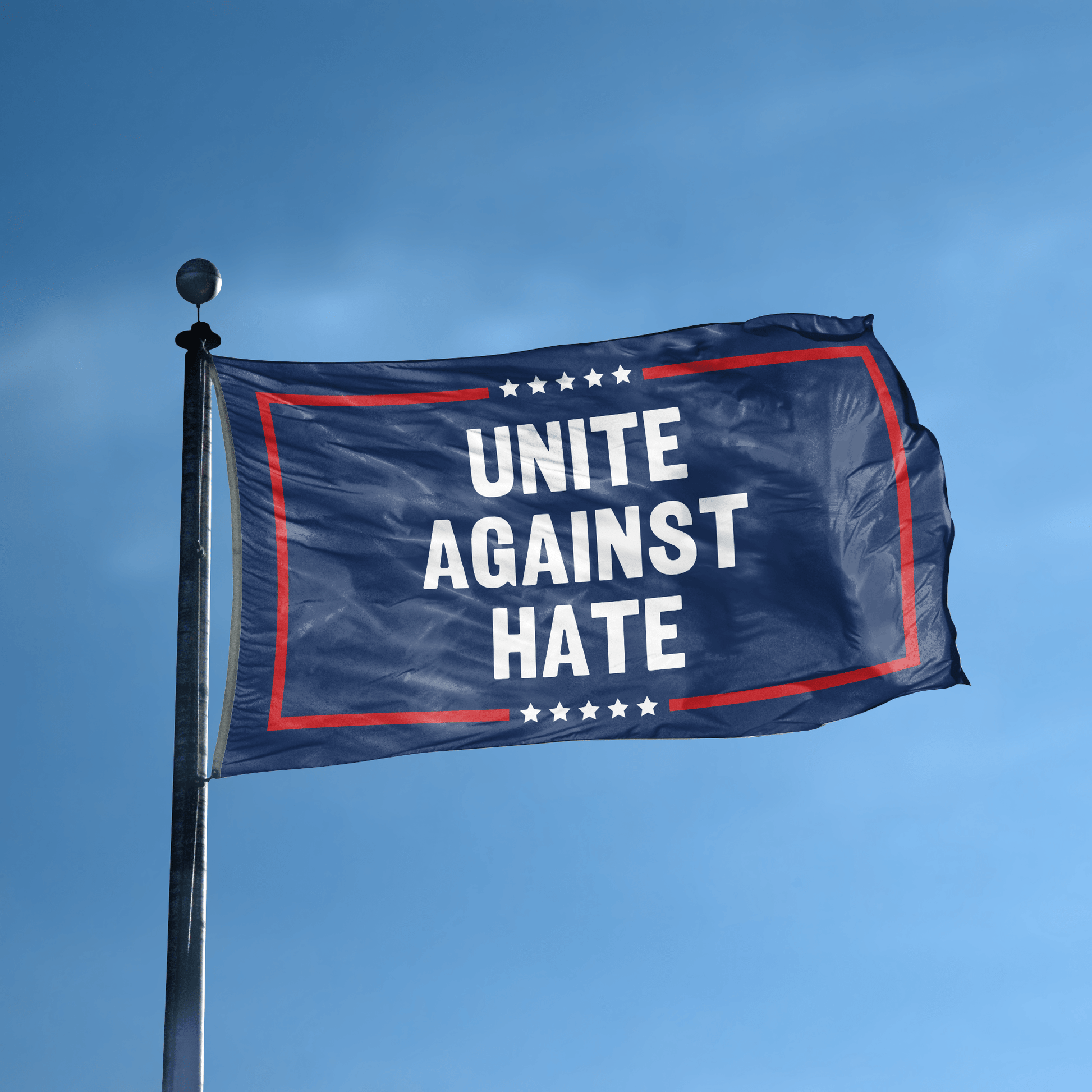 A flag with the saying "Unite Against Hate Political" displayed on a high pole, with a red, white, and blue color scheme.