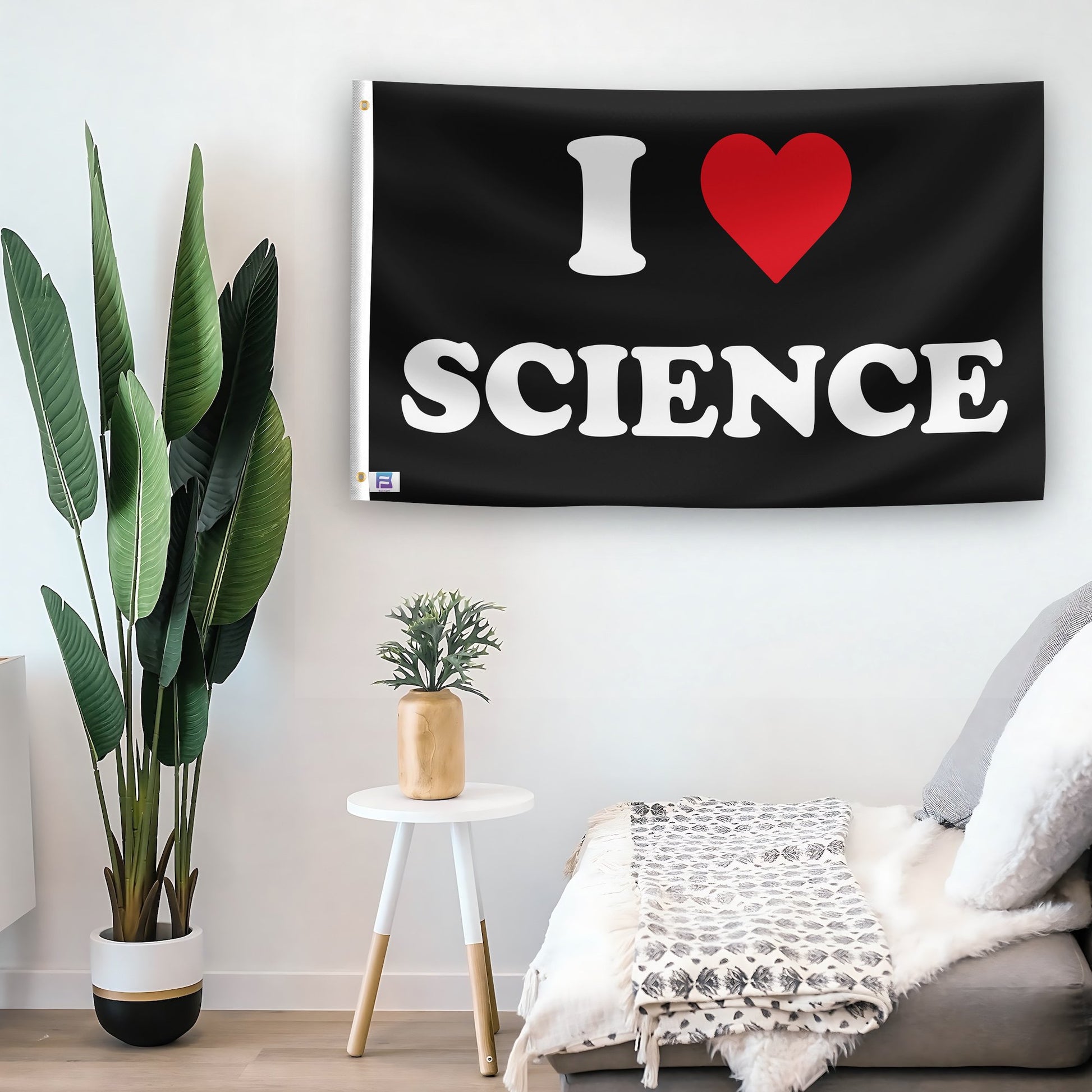 In a home setting, a flag with the saying "I Love Science" is mounted on a white wall by a side table.