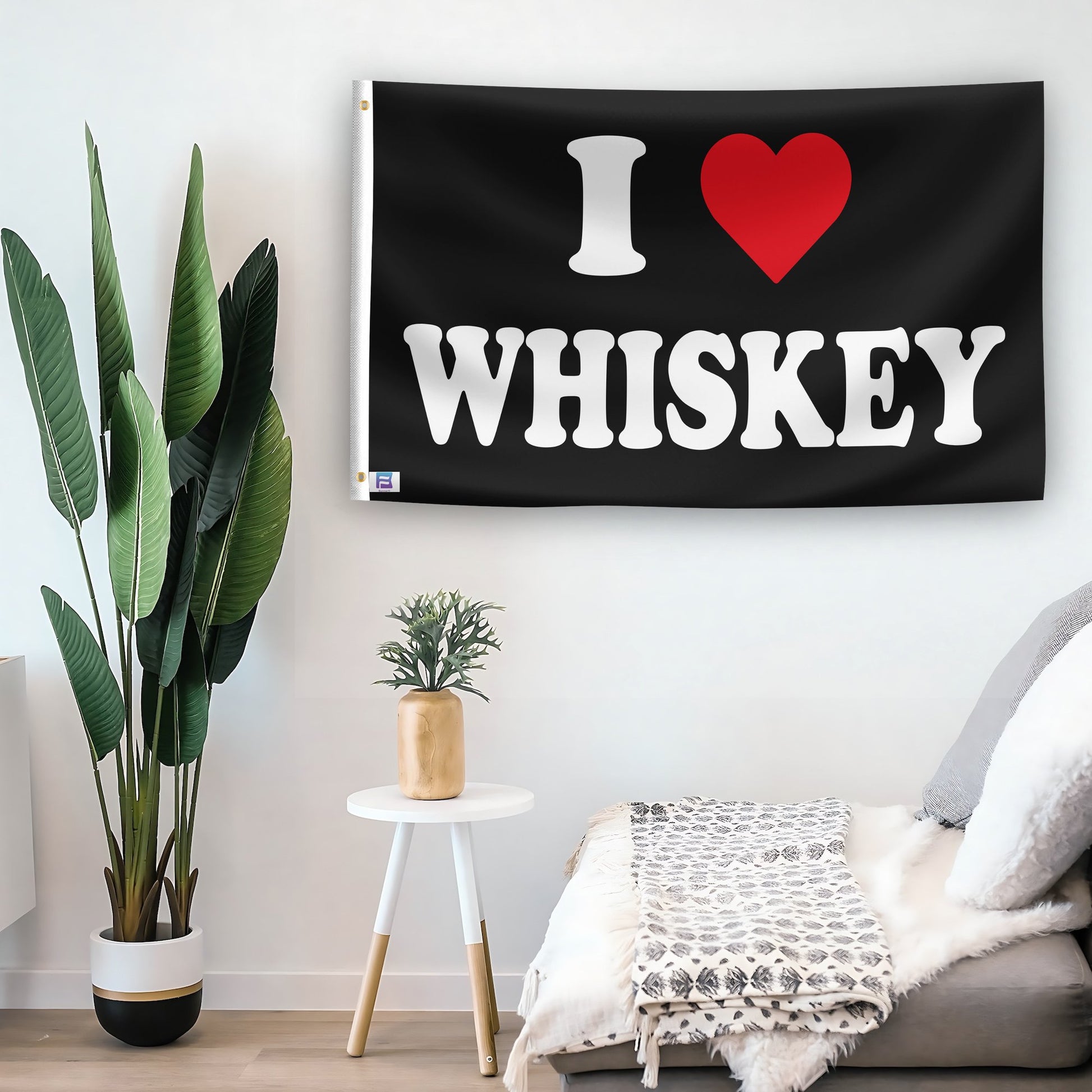 In a home setting, a flag with the saying "I Love Whiskey" is mounted on a white wall by a side table.