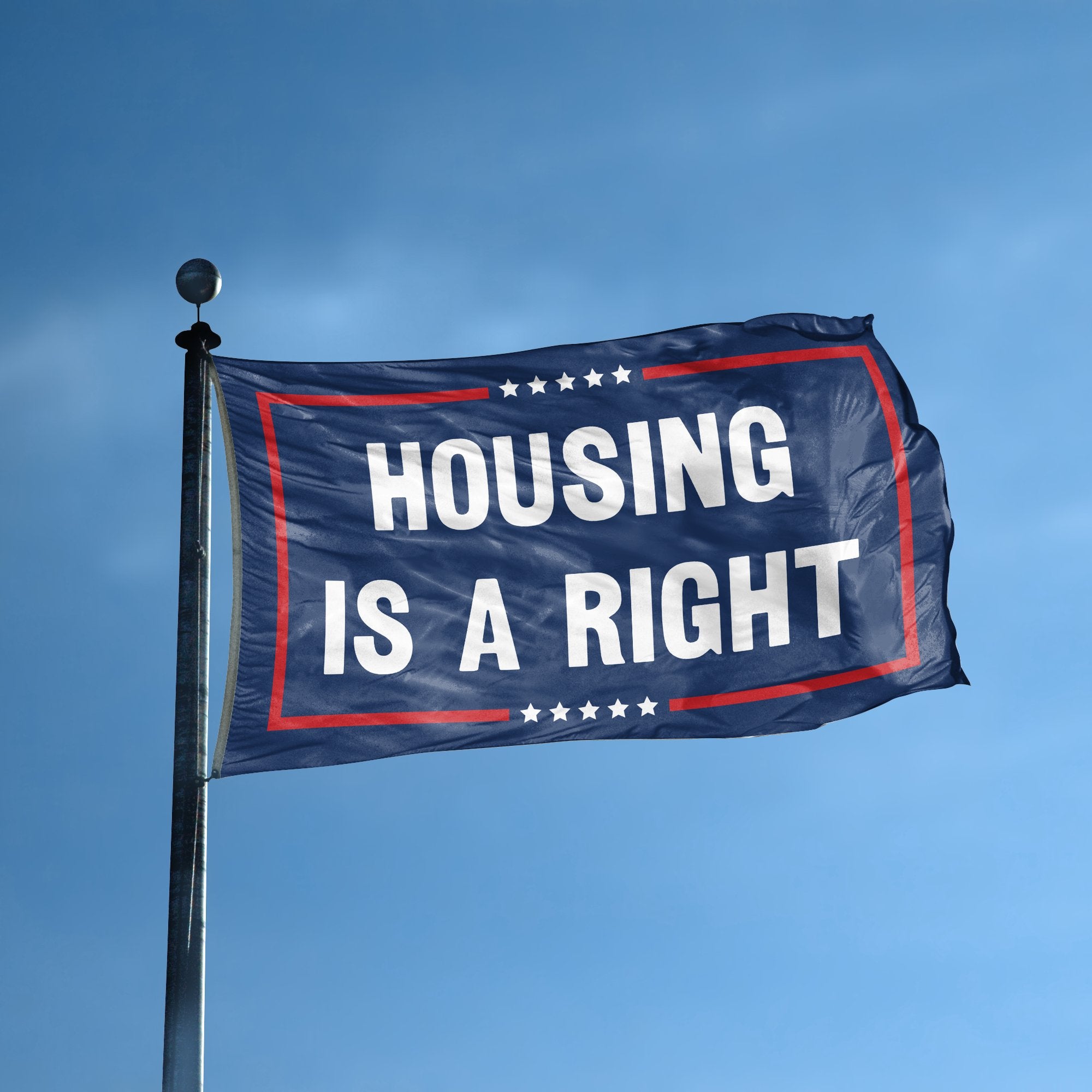 A flag with the saying "Housing Is A Right Political" displayed on a high pole, with a red, white, and blue color scheme.