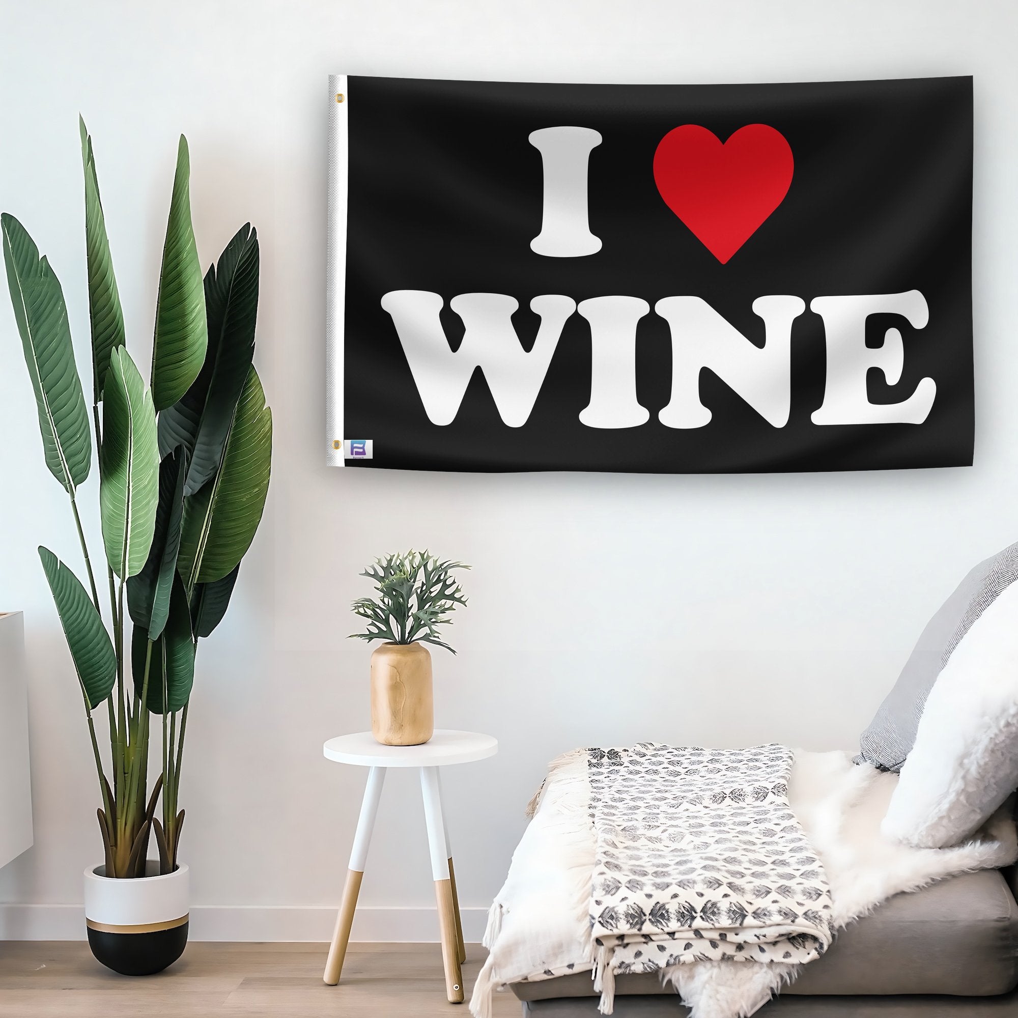 In a home setting, a flag with the saying "I Love Wine" is mounted on a white wall by a side table.