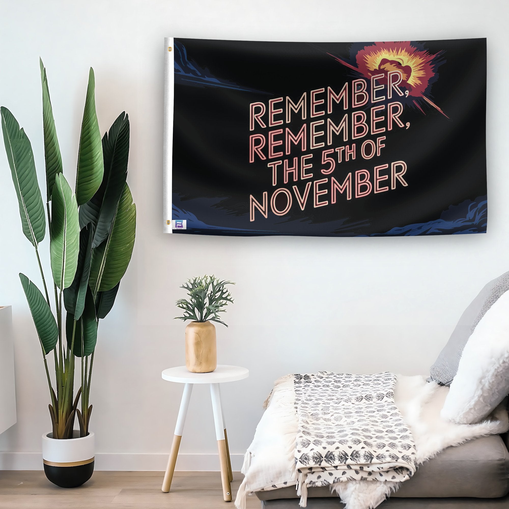 In a home setting, a flag with the saying "Remember Remember The 5th Of Novermber Holiday" is mounted on a white wall by a side table.