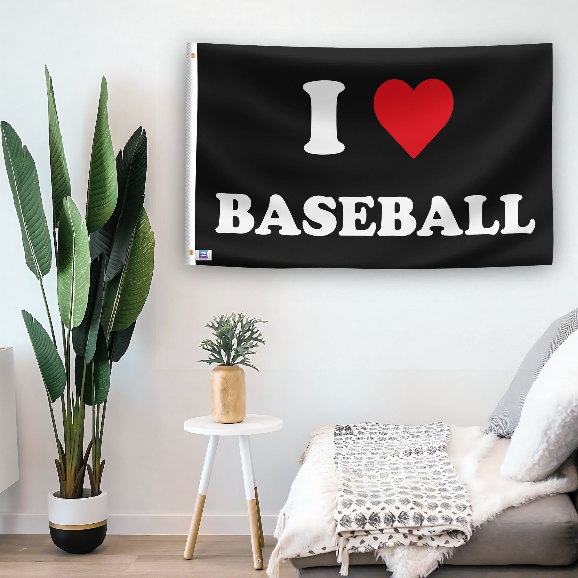 In a home setting, a flag with the saying "I Love Baseball" is mounted on a white wall by a side table.