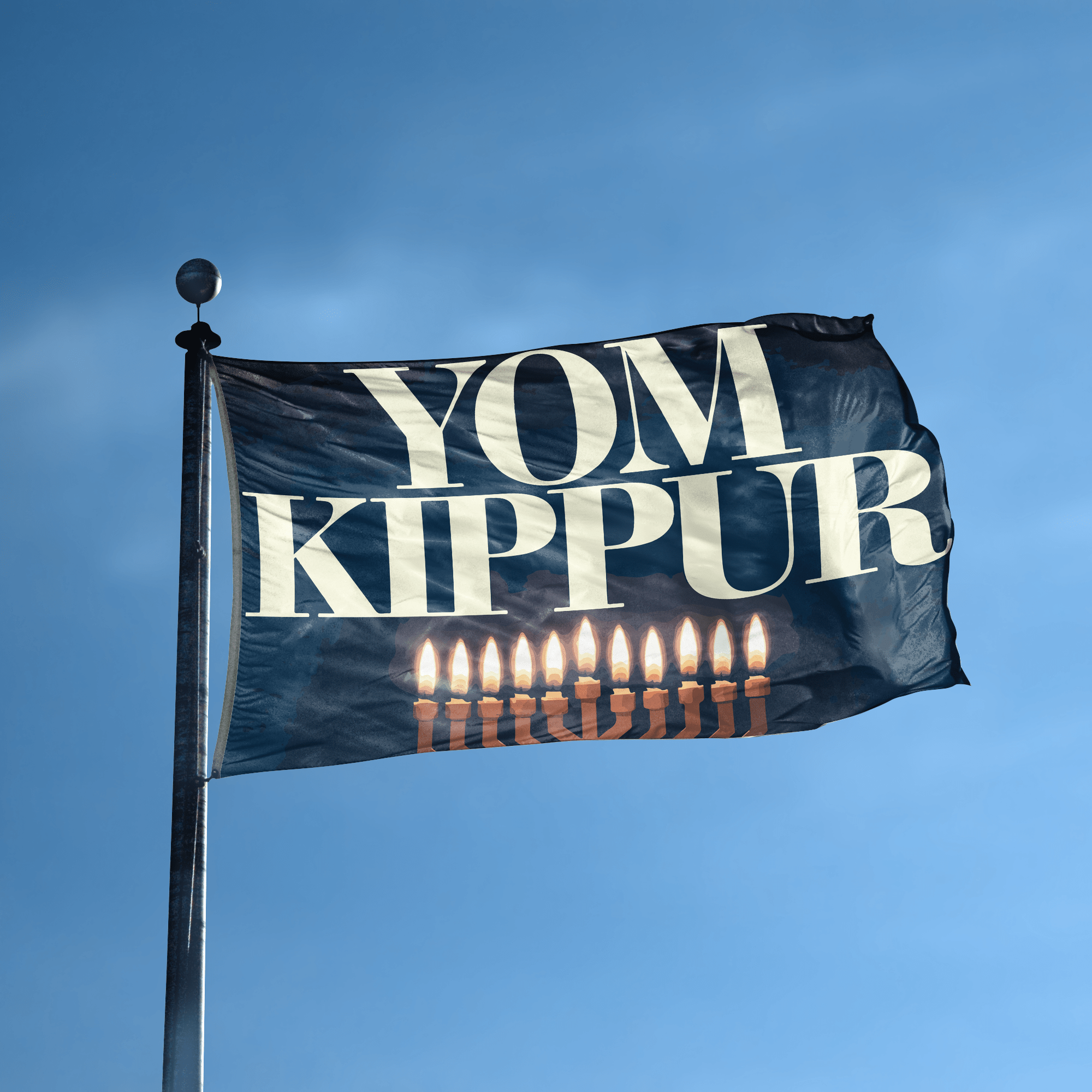 A flag with the saying "YOM Kippur" displayed on a high pole, with a holiday themed color scheme.