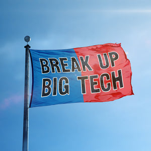 A flag containing a political slogan displayed on a high pole, featuring a patriotic red and blue background.