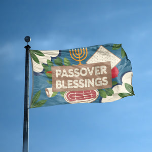 A flag with the saying "Passover Blessings" displayed on a high pole, with a holiday themed color scheme.